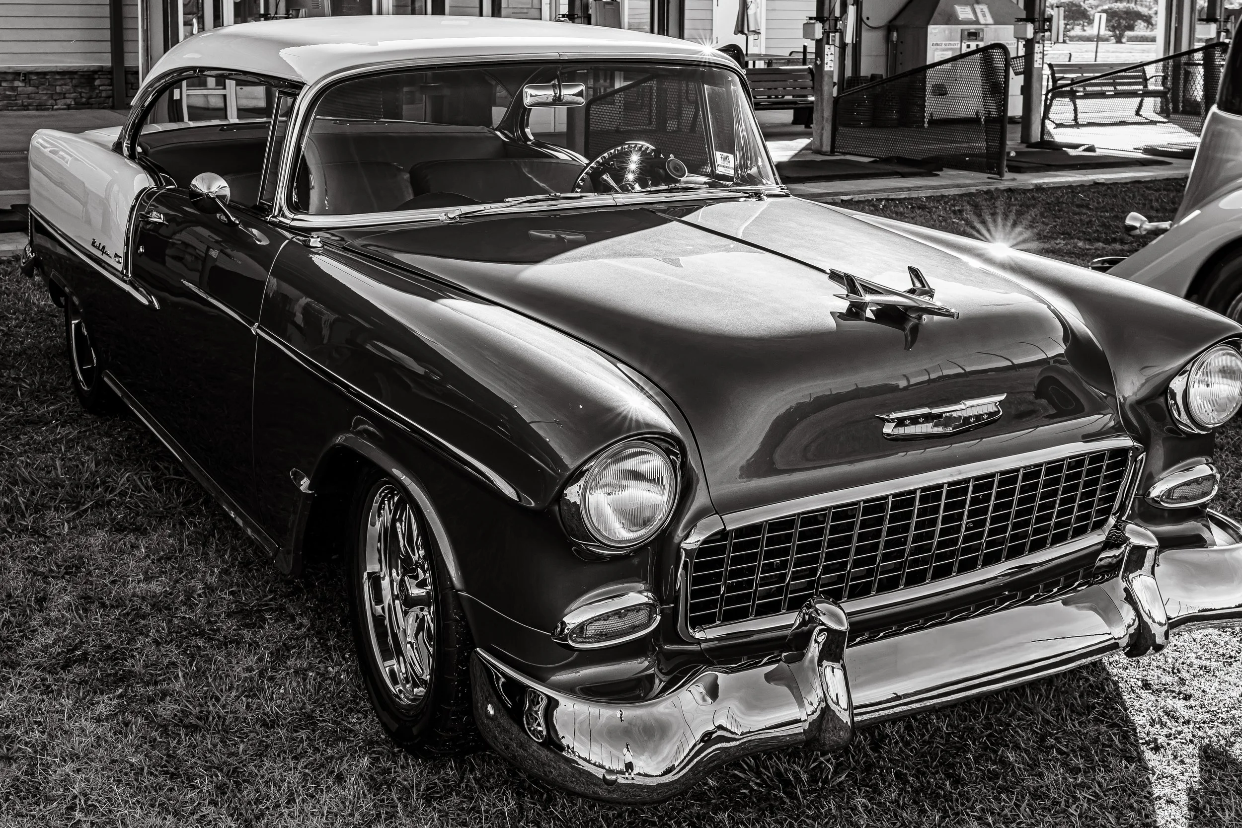 Check out this gorgeous old Chevrolet! It’s just a simple black-and-white photo, but the design is so stunning. The chrome grille totally pops, and that bird hood ornament is such a cool, classic touch.