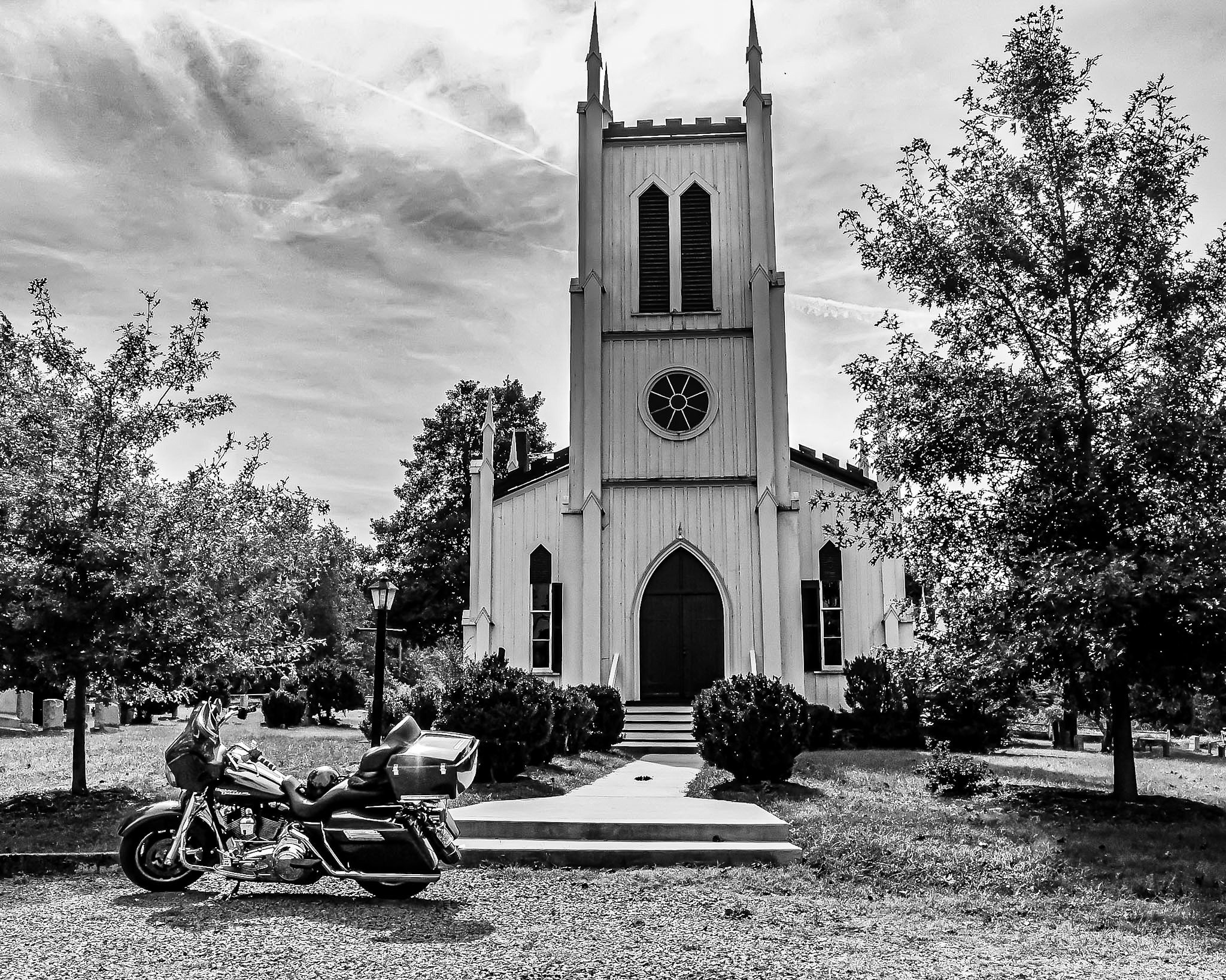 A quiet morning stop. My Harley sitting framed perfectly against the walls and towering spires of this old church, surrounded by nothing but trees and the open air. Just us, the road, and a moment of peace before hitting the open road again.