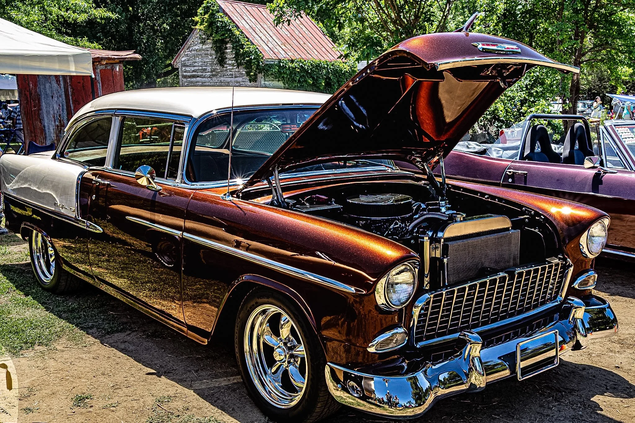 There’s nothing quite like the energy of an outdoor show, especially when the hood is up and you get a clear look at the heart of a machine. I caught this shot of this classic parked with its immaculate engine bay completely on display. Framed by a b
