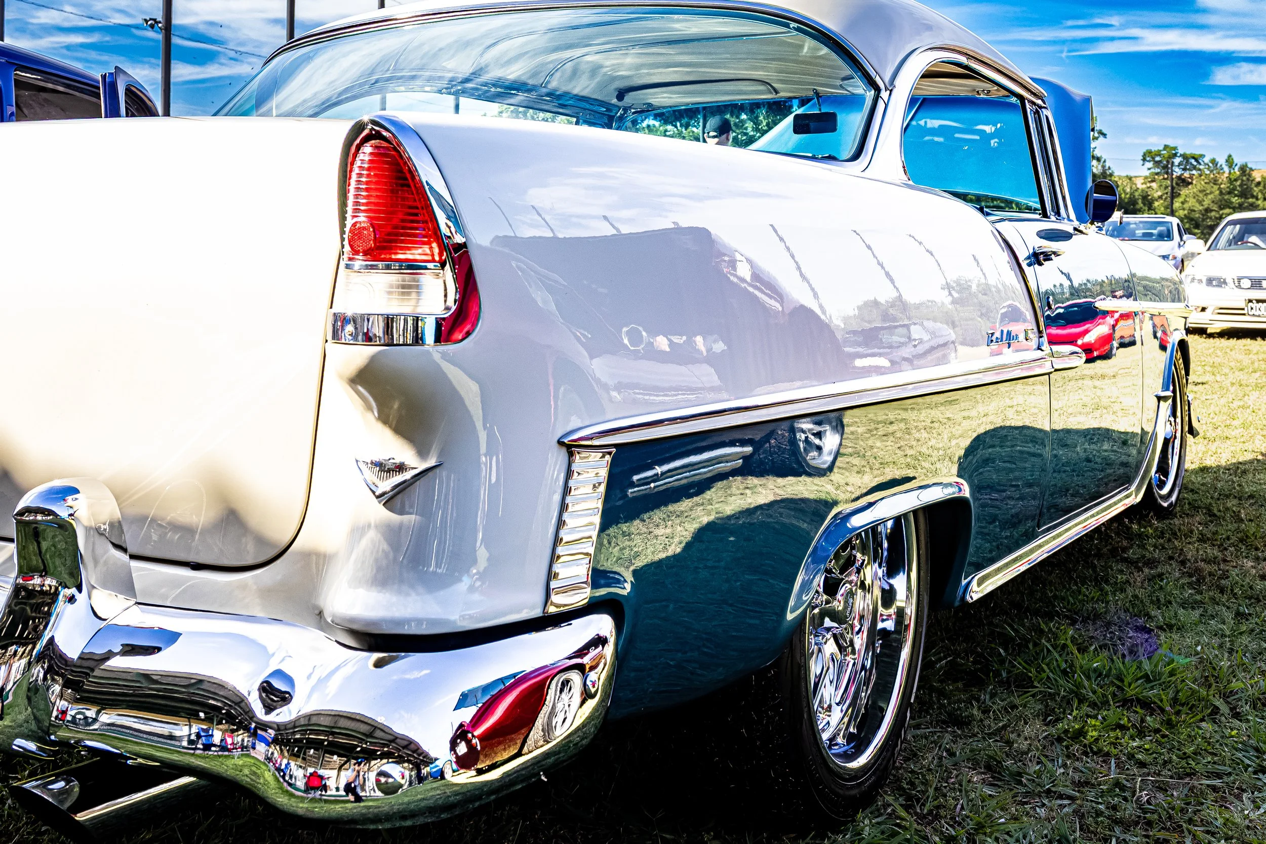 I caught sight of this stunning vintage classic at the local outdoor show—all gleaming white paint and perfectly polished chrome. Looking closely at its flawless, shiny surface, you could actually see the reflections of the crowd and the other cars s