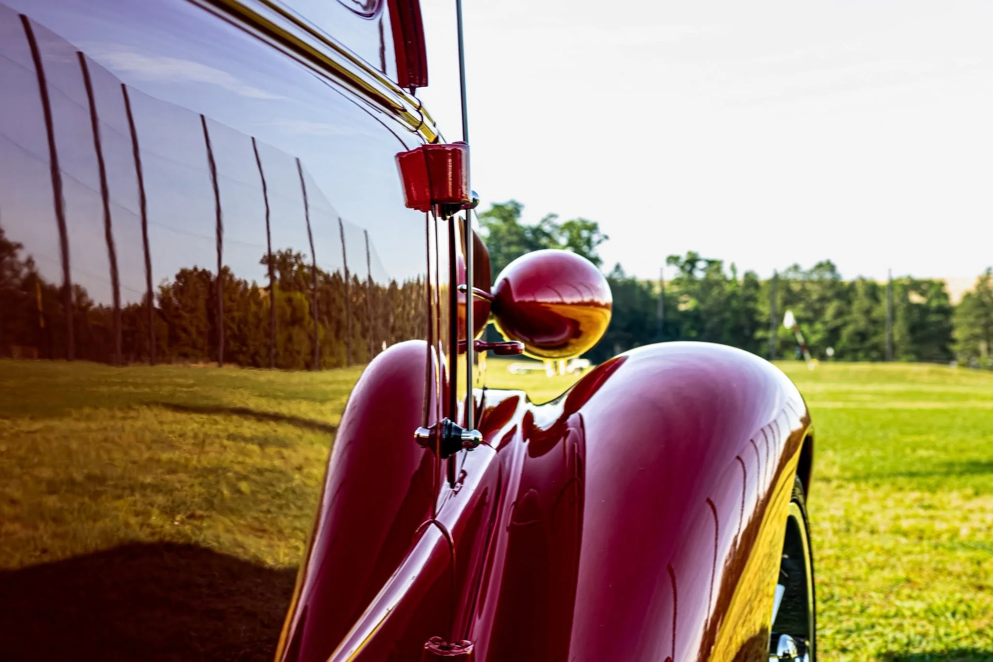 Capturing the timeless lines and detailing of a classic Chevy. I love using natural light to bring out the depth of these vintage curves, set against the soft texture of a fenced field and a vibrant summer sky. No formal studio needed—just patience, 