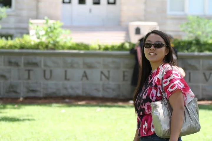 Dr. Cassie Lopez-Jeng standing in front of a Tulane University sign.