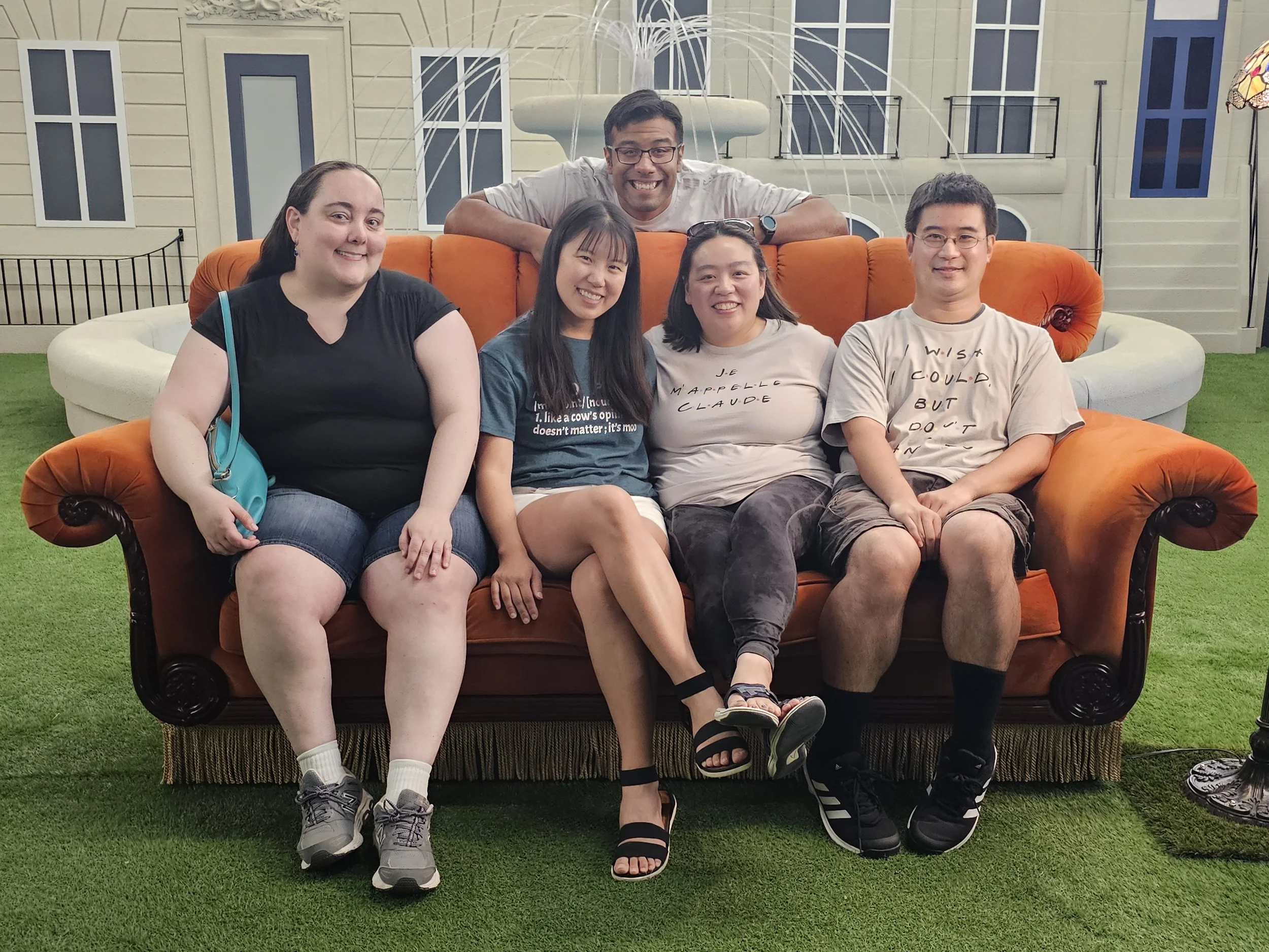 Dr. Cassie Lopez-Jeng and her friends sitting on the Friends couch.