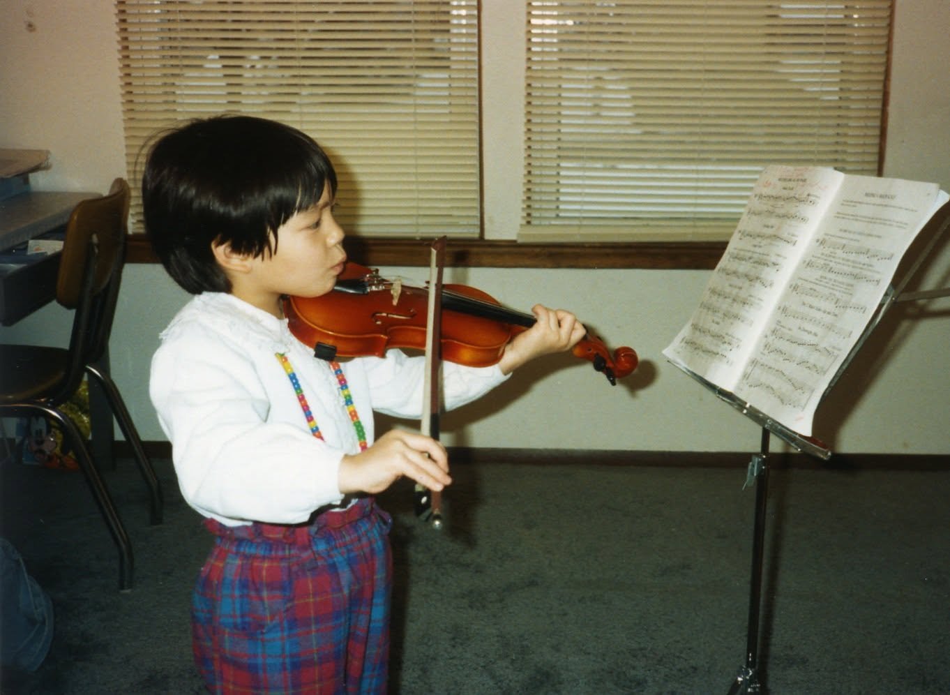 Dr. Cassie Lopez-Jeng as a child playing the violin.