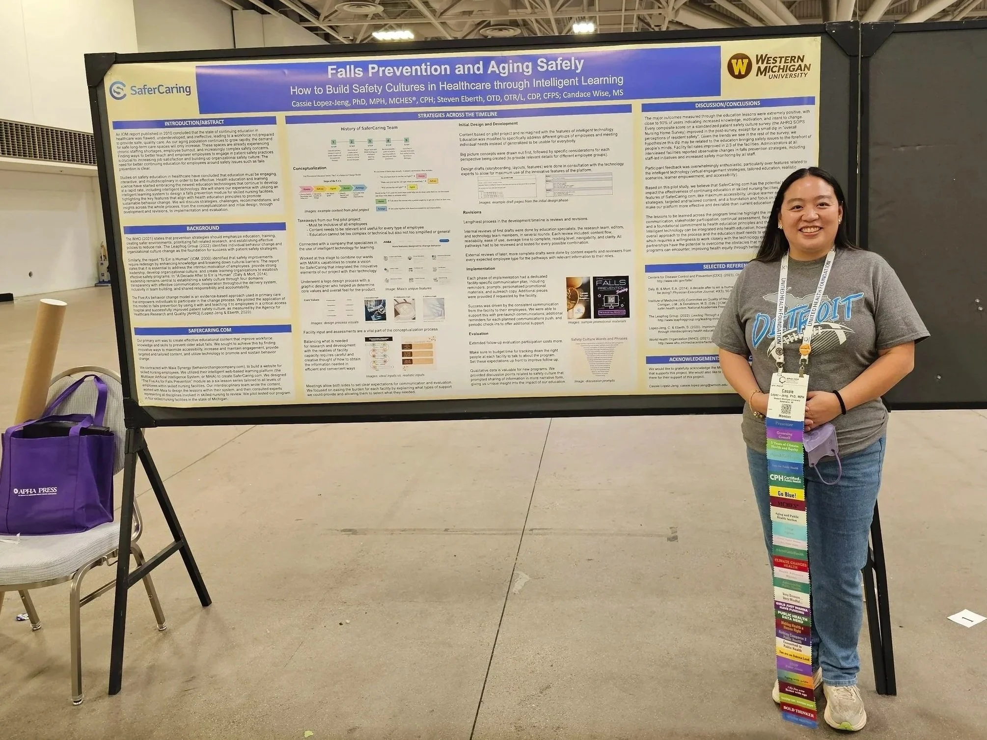 Dr. Cassie Lopez-Jeng standing next to a poster presentation titled "Falls Prevention and Aging Safely."