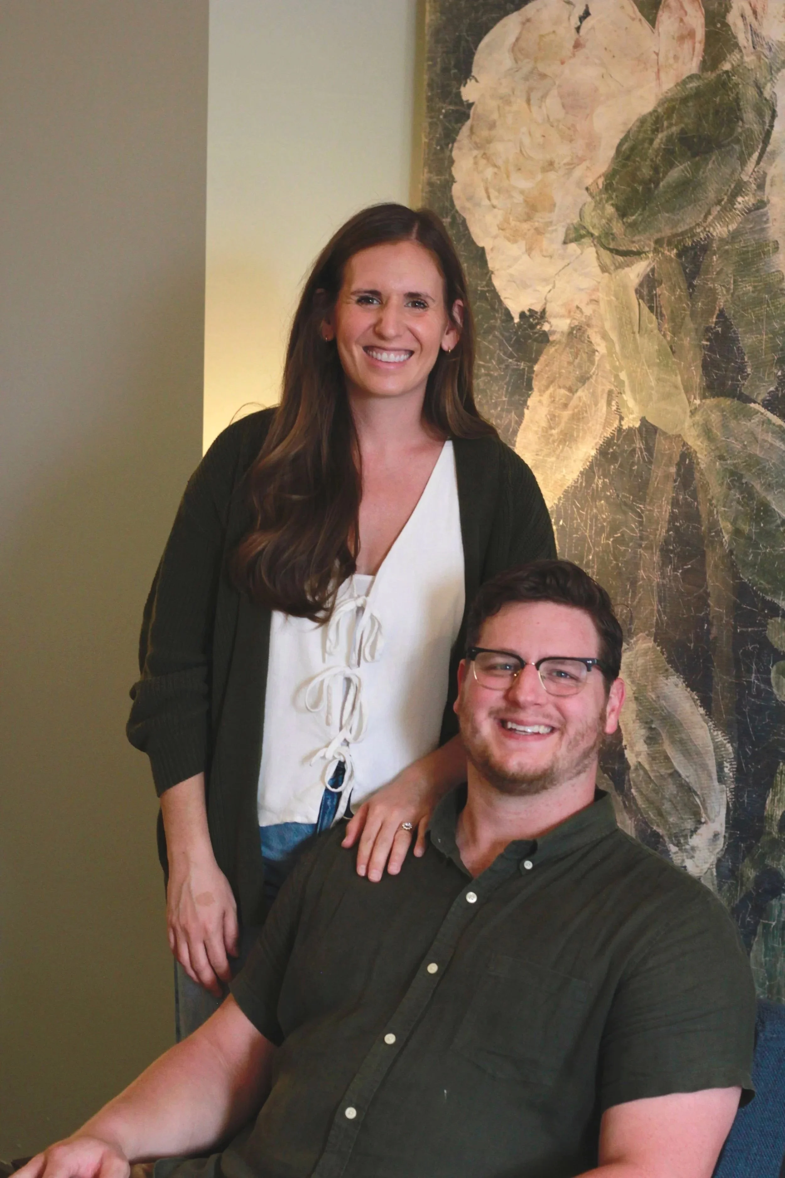 Mary Grace and Andrew Parks, a married counseling duo, smiling in their office.