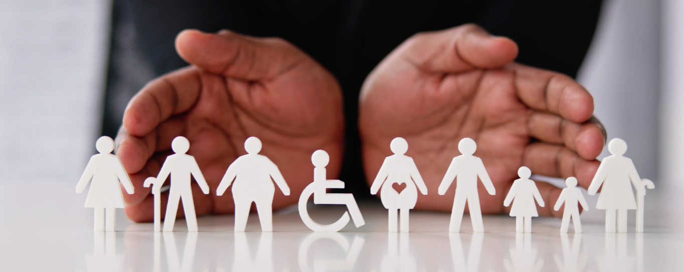 A pair of hands behind paper cutouts of people