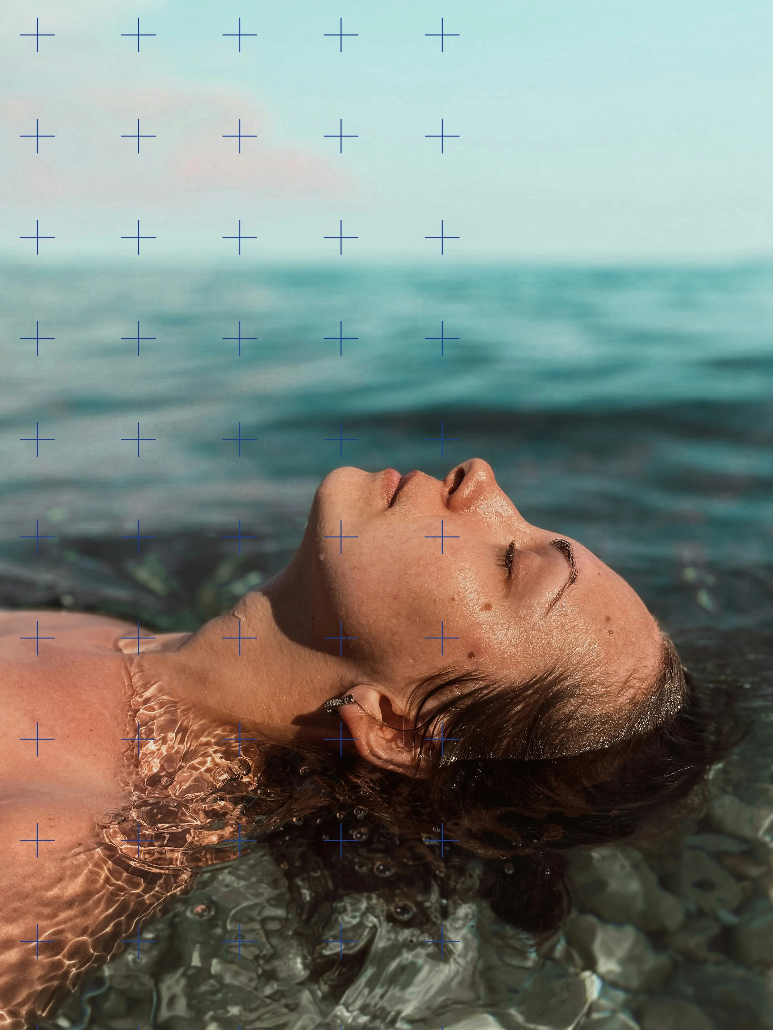Sea Wisdom post-swim skincare brand image of a woman floating on her back in the water, eyes closed, face and upper body partially submerged, with water rippling around her.