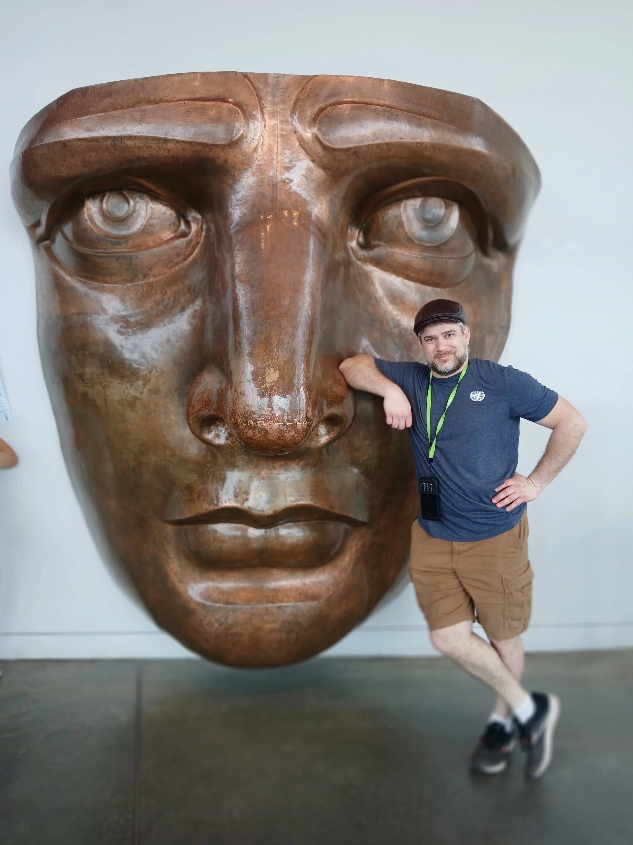 Benton standing next to a replica of the Statue of Liberty's face in the Statue of Liberty museum in New York City