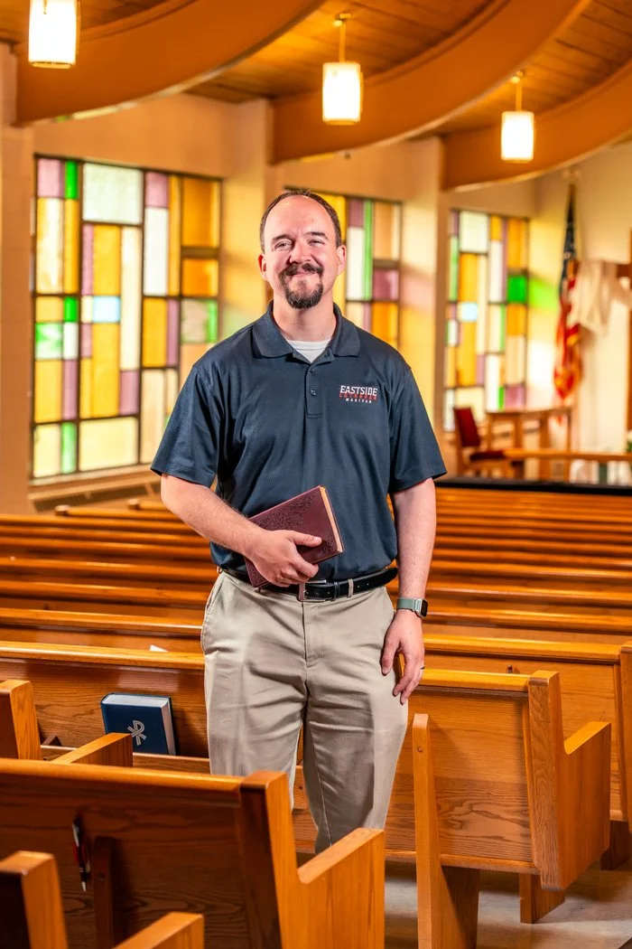 Pastor Walther standing inside Eastside Lutheran Church.