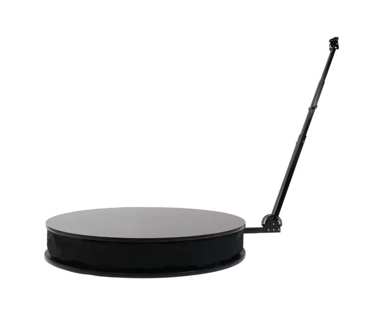 A round, black platform with an extendable arm attached to the side.