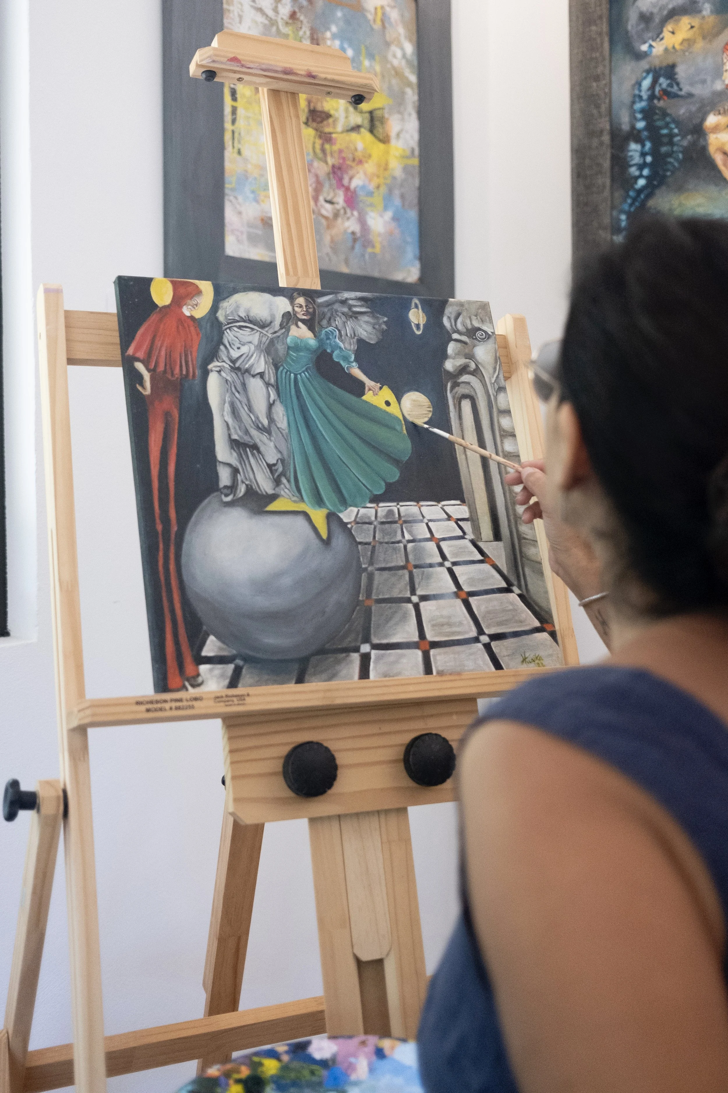 The picture shows the contemporary visual artist in her studio, meanwhile work oil panting fine art, cosmic and spiritual art.