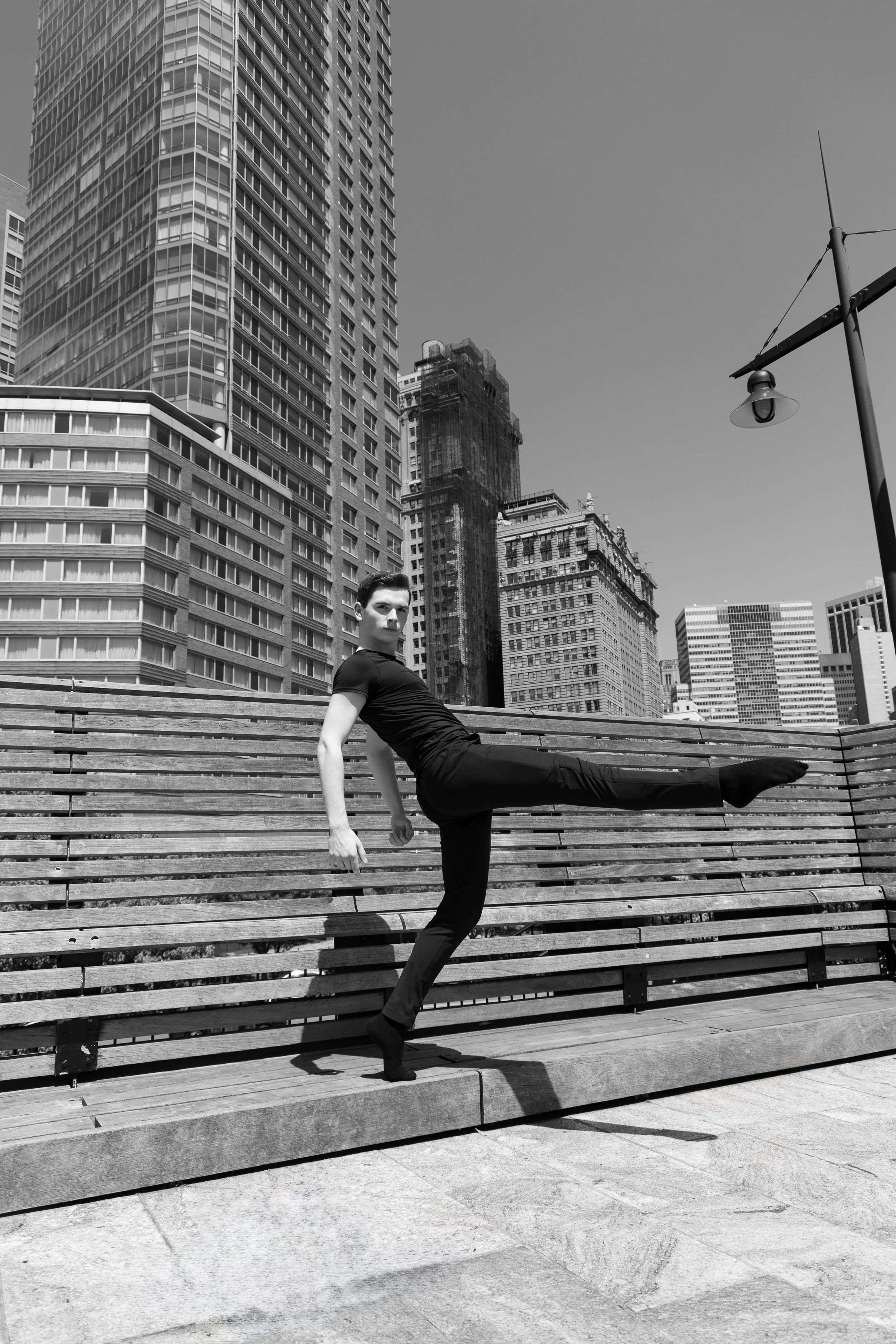 Dance photo of Burke Brickner against the Battery Park, New York City skyline, captured by Wyatt Florin (2022)