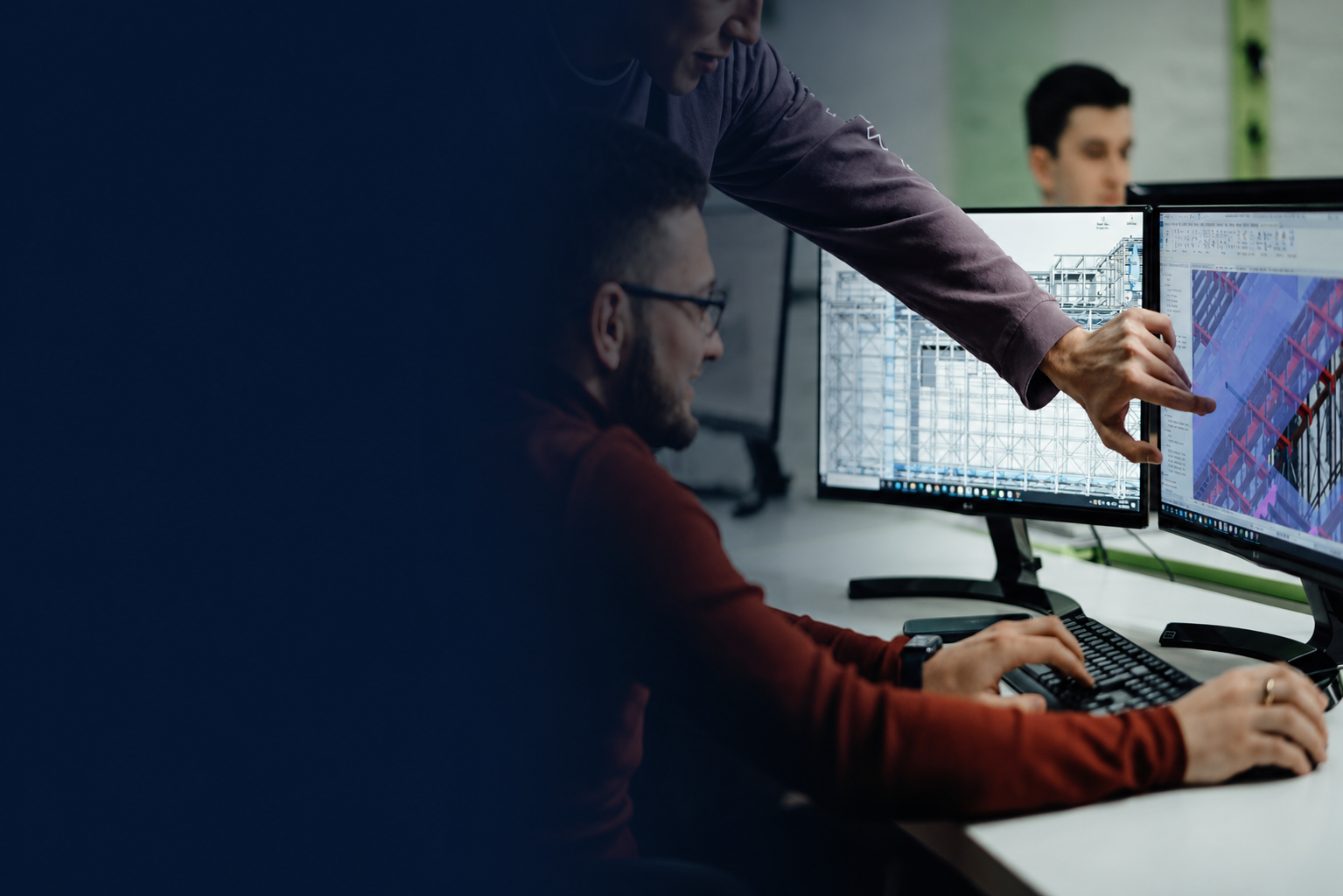 Engineering professionals reviewing technical designs on computer monitors.