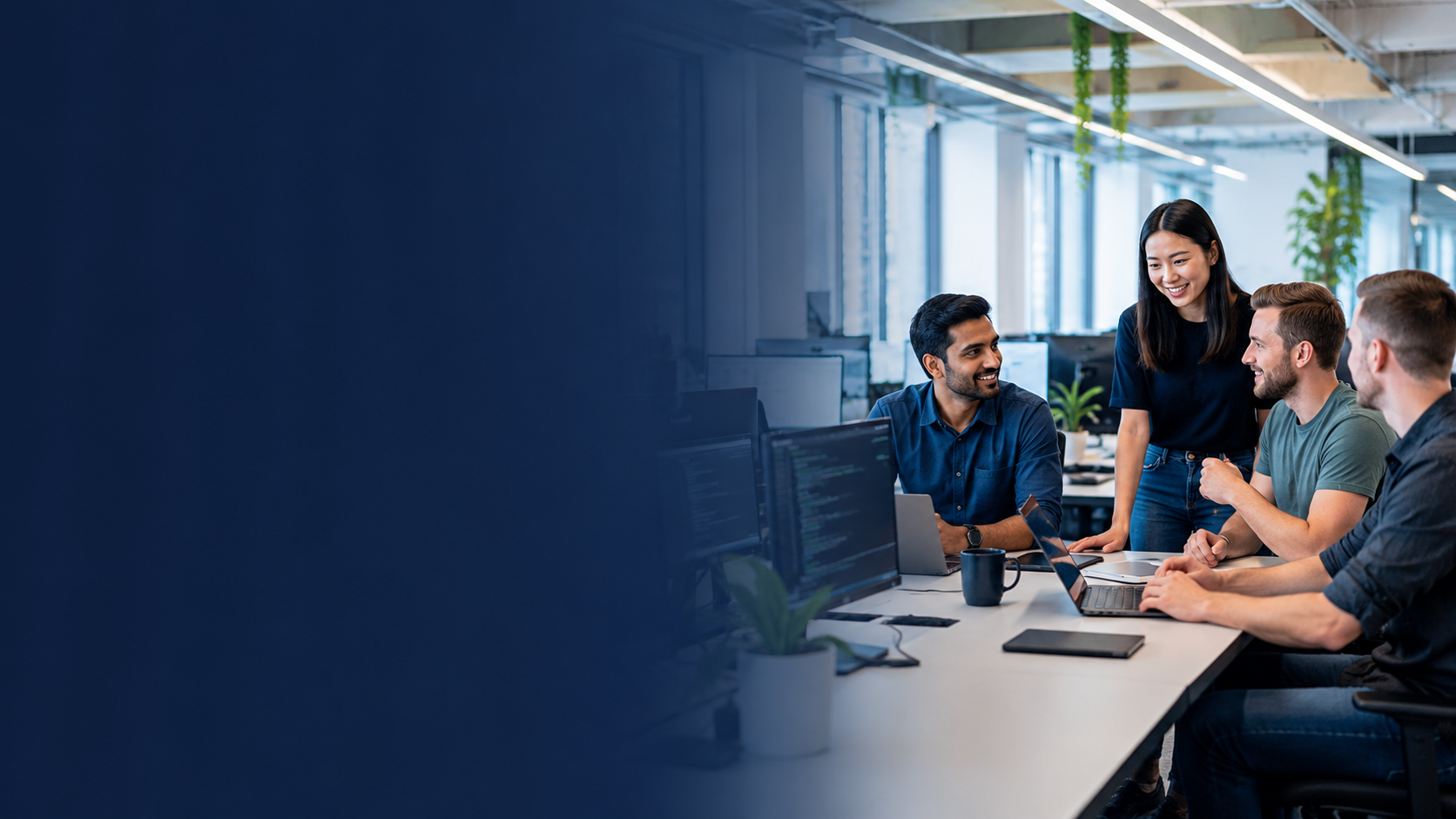 Technical professionals collaborating around a table in a modern office.