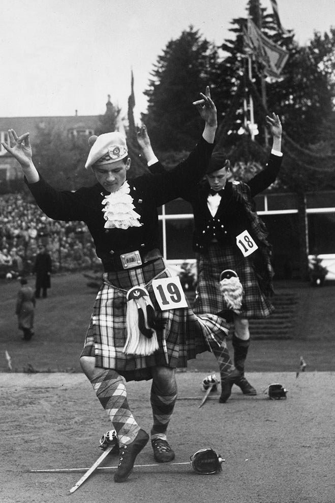 Two men dressed in traditional Scottish attire performing the Sword Dance.