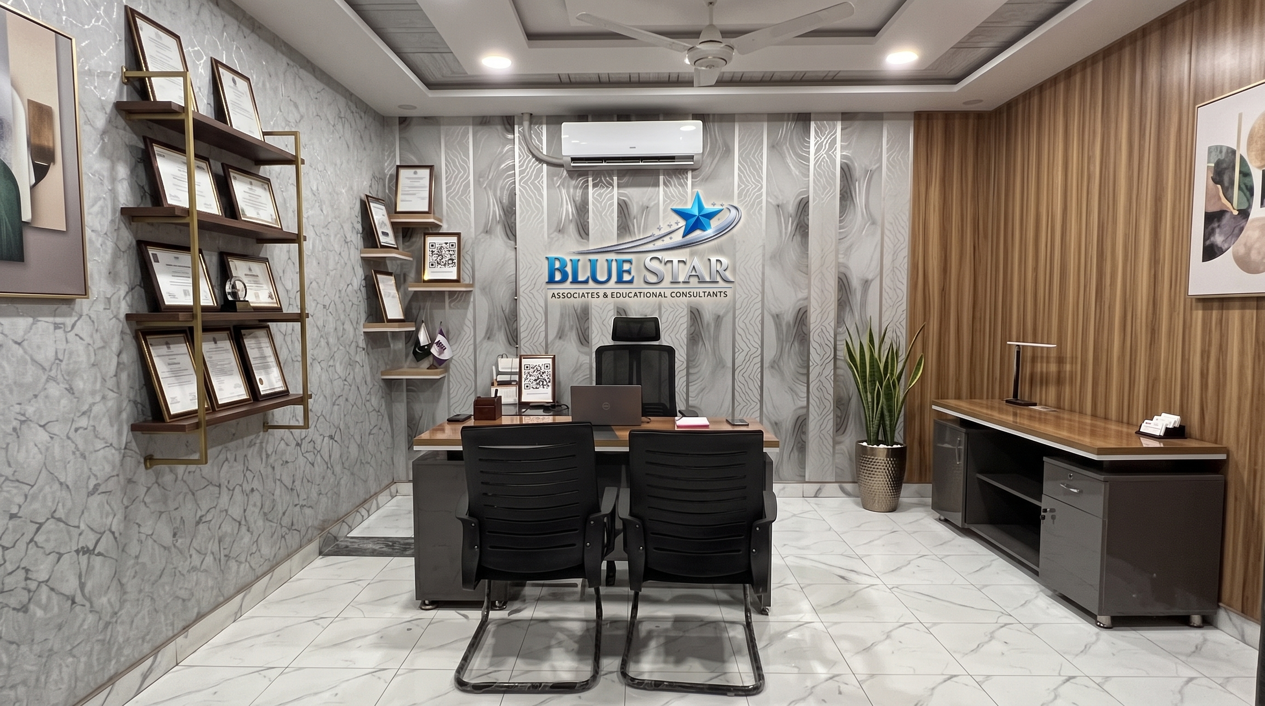 Office reception area with a desk, four chairs, wall-mounted shelves with framed certifications, a potted plant, and artwork on the walls. The company's logo 'Blue Star Associates & Educational Consultants' is displayed on the wall behind the desk.
