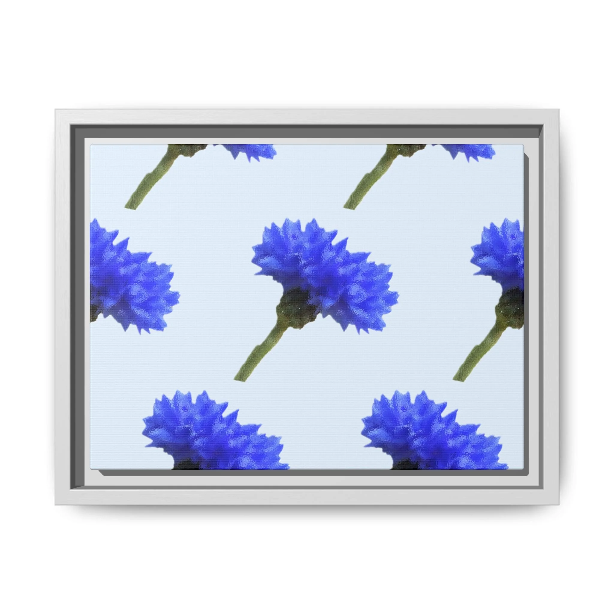 White framed print with a screen displaying a pattern of blue flowers with green stems.