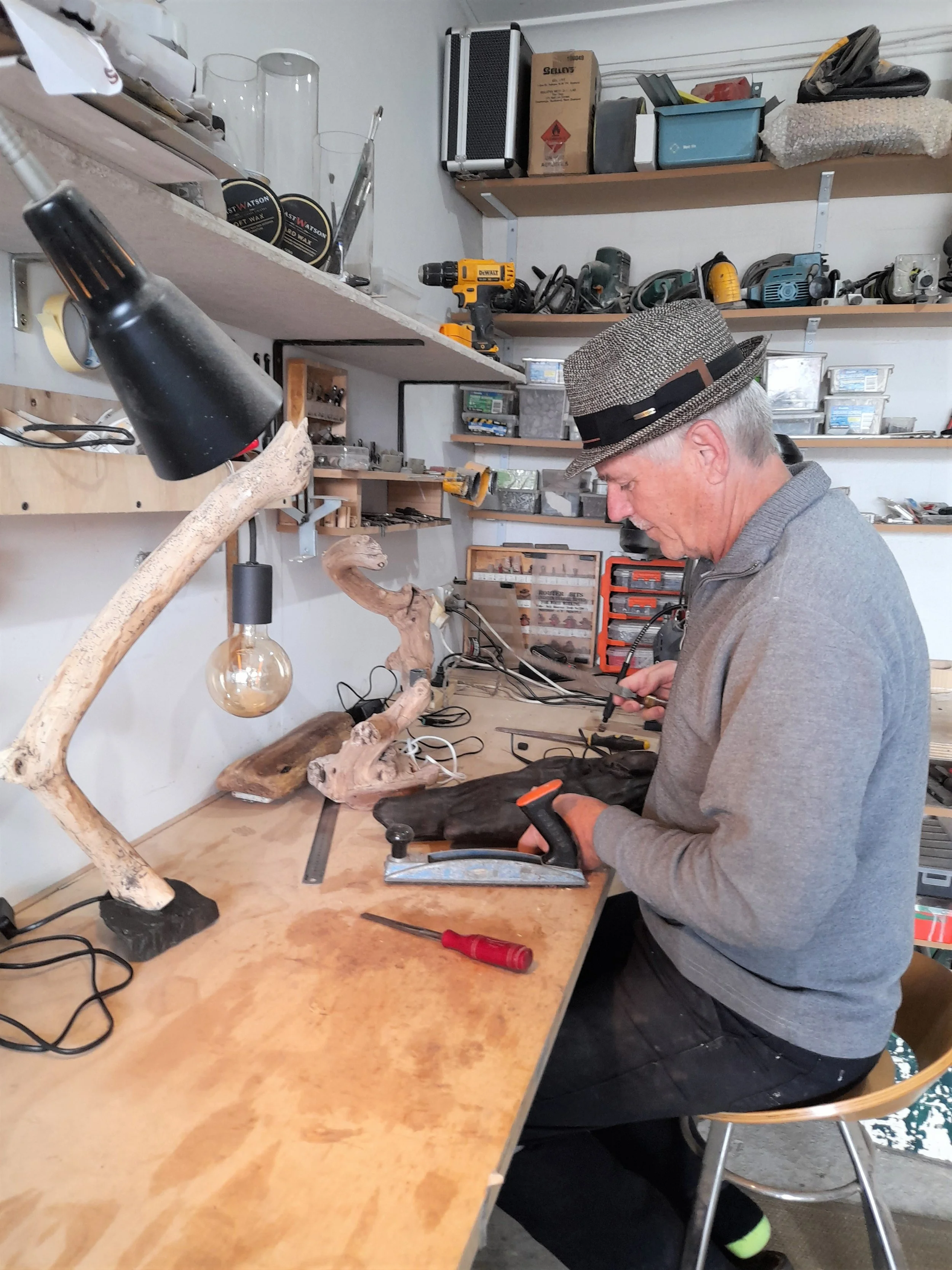 Wood sculptor Ole Jensen hand-carving salvaged coastal timber in his studio