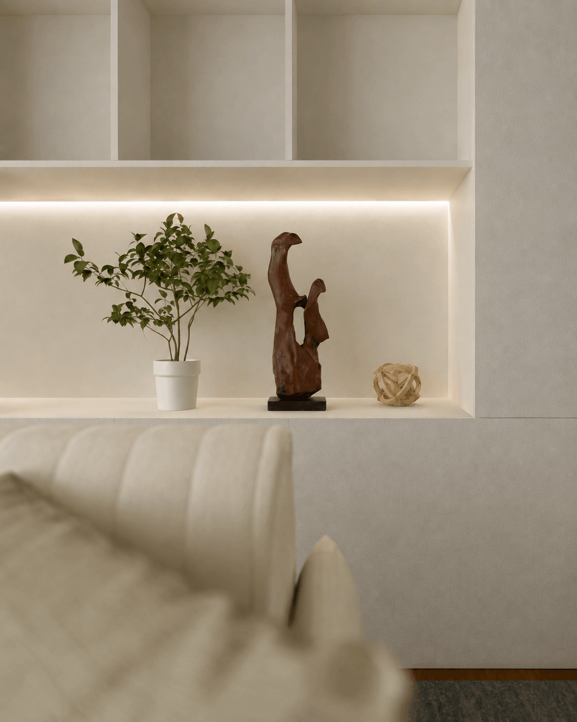 Hold On hand-carved fine art timber sculpture by Ole Jensen displayed on a lit architectural shelf in a modern luxury living room.