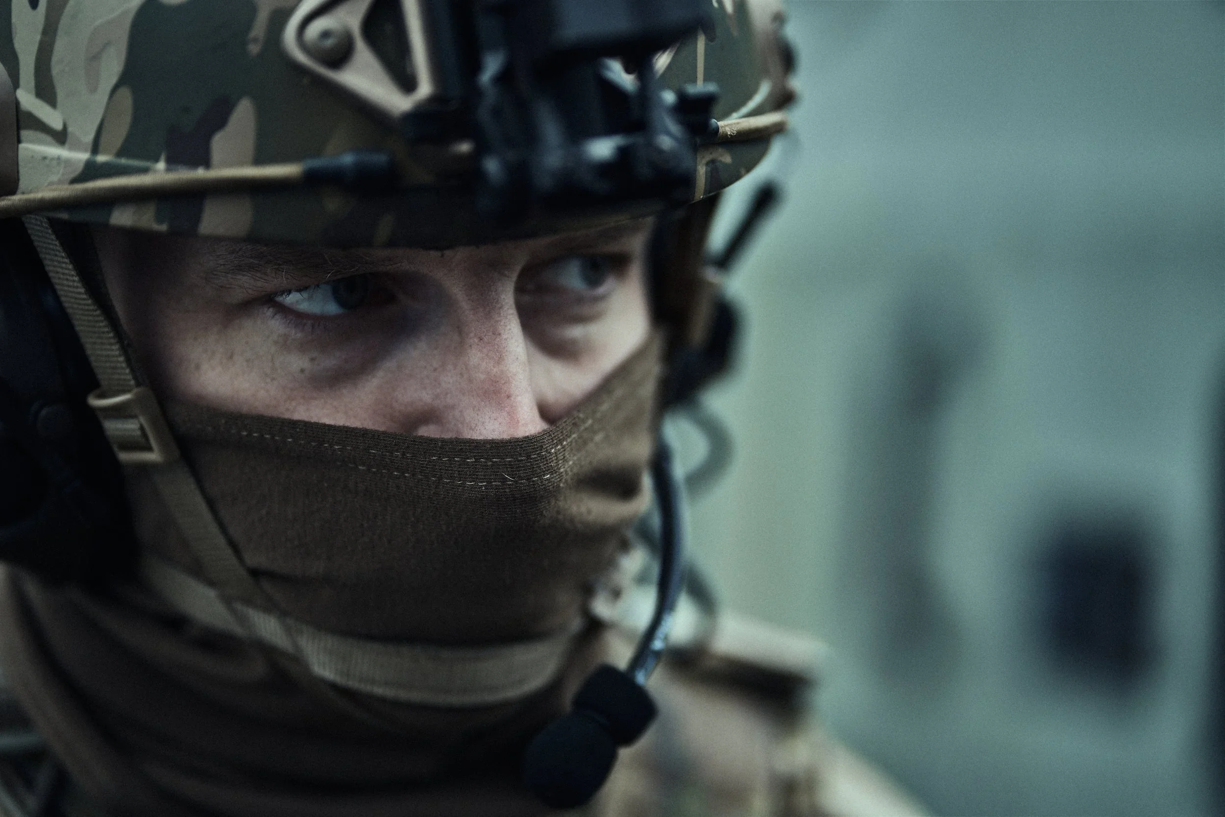 Close-up of a Shelby County Sheriff’s Office tactical deputy wearing a camouflage helmet and face covering.