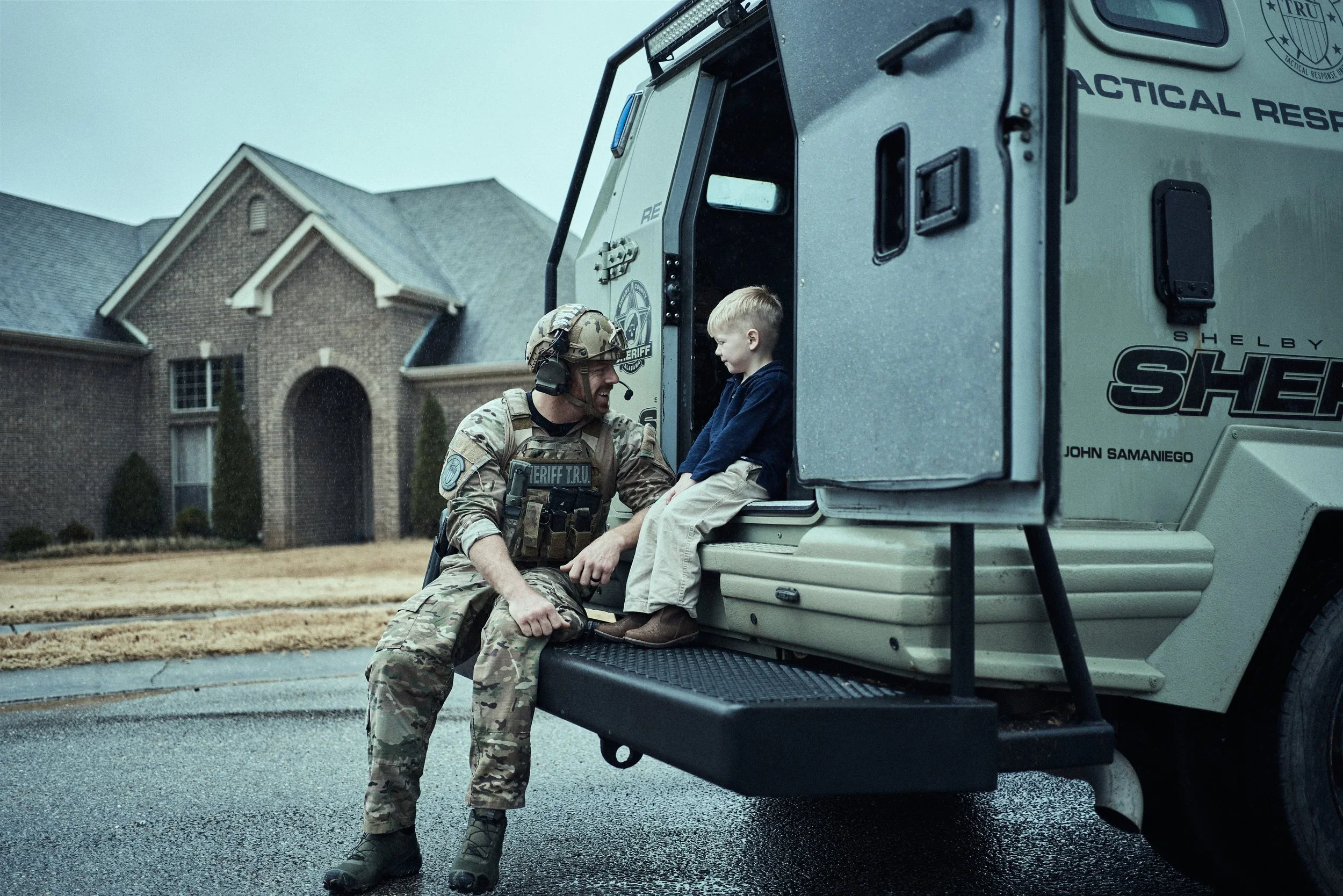 A Shelby County Sheriff’s Office tactical deputy speaks with a young boy inside an armored vehicle during a community event.
