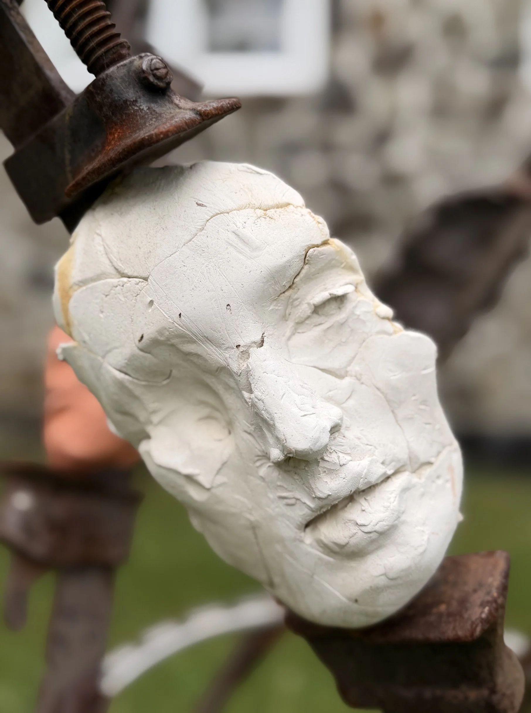The Tribunal, outdoor sculpture by New York sculptor Aleksandra Scepanovic featuring reclaimed industrial steel and fired clay figures. Porcelain clay face detail