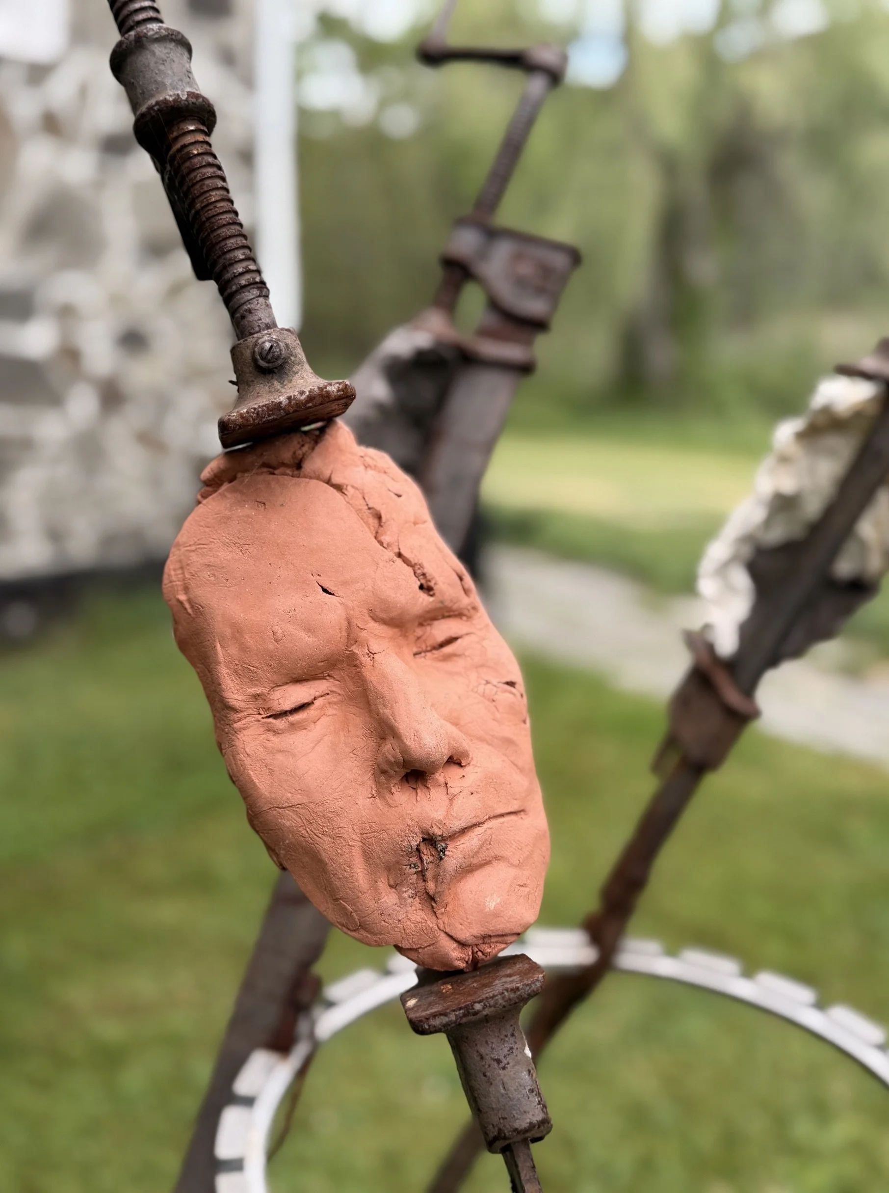 The Tribunal, outdoor sculpture by New York sculptor Aleksandra Scepanovic featuring reclaimed industrial steel and fired clay figures. Fed clay face detail front