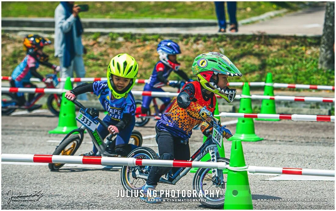 Children's cycling competition photography during L'Étape Malaysia, capturing young athletes in action.