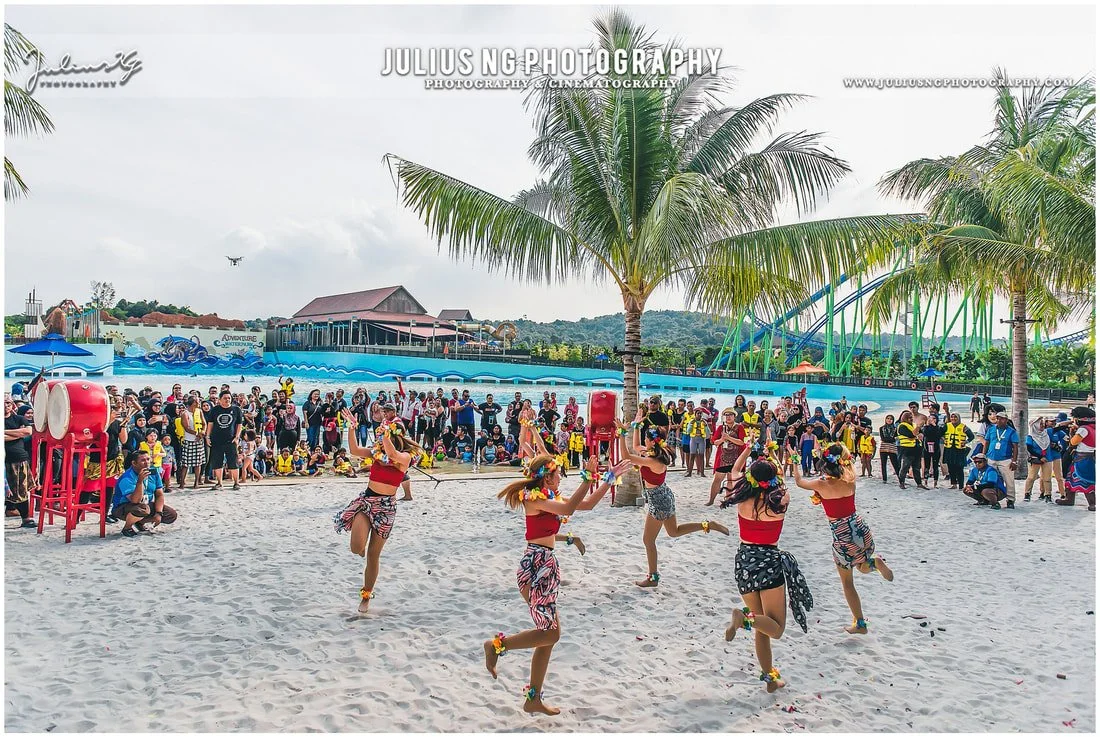 Outdoor entertainment performance during Adventure Waterpark Desaru Coast anniversary event with guests enjoying the celebration.