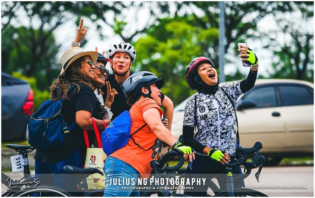 Participants enjoying the atmosphere before the L'Étape Malaysia by Tour de France cycling event, photographed by Julius Ng Photography.