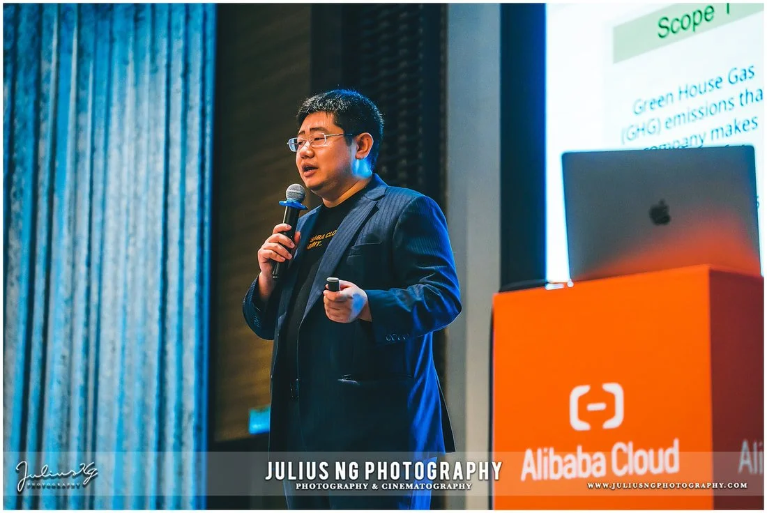 Conference speaker photography during Alibaba Cloud technology seminar and corporate event.