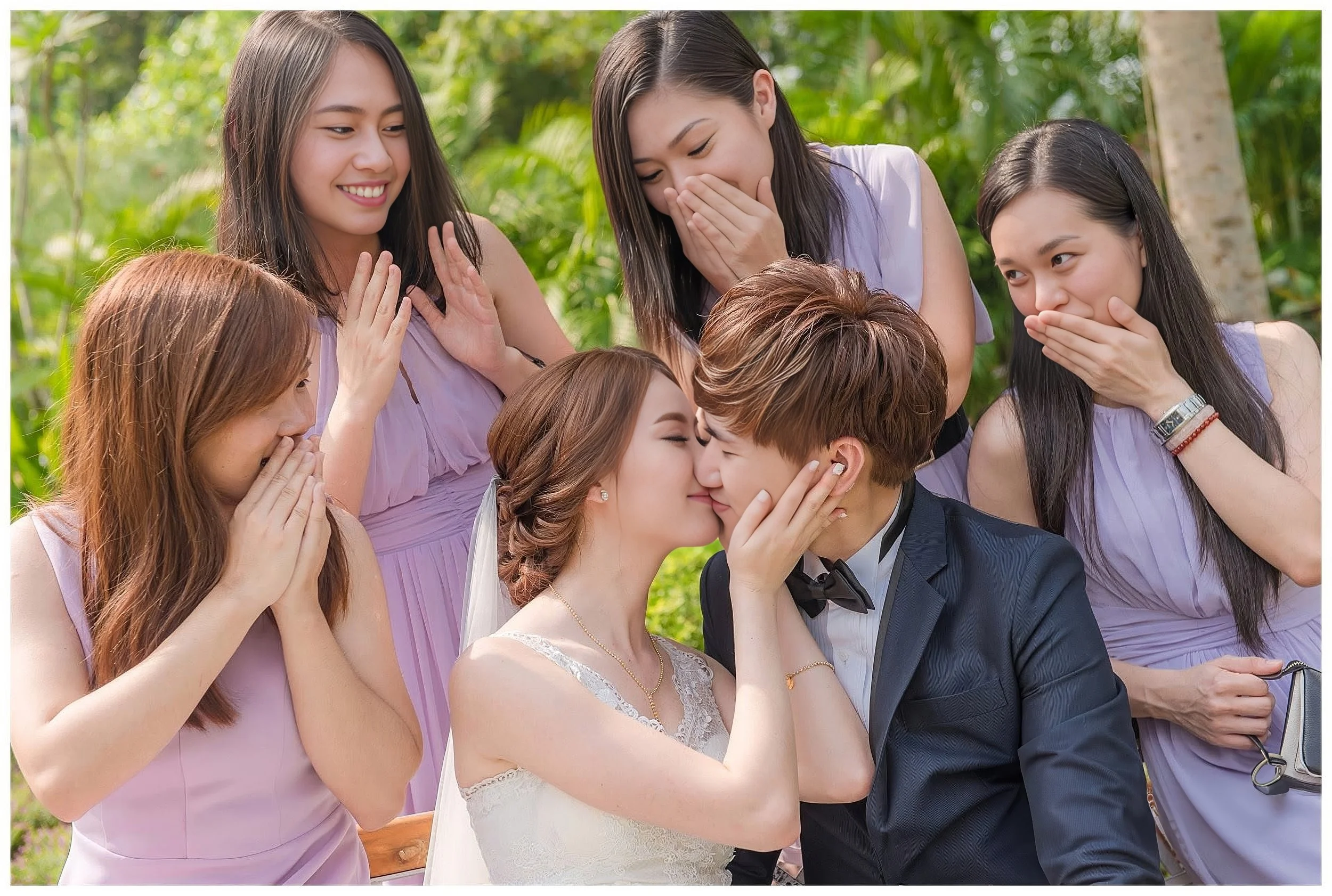 Sze Fong and Lai Yen sharing a joyful moment with their bridesmaids on their wedding day