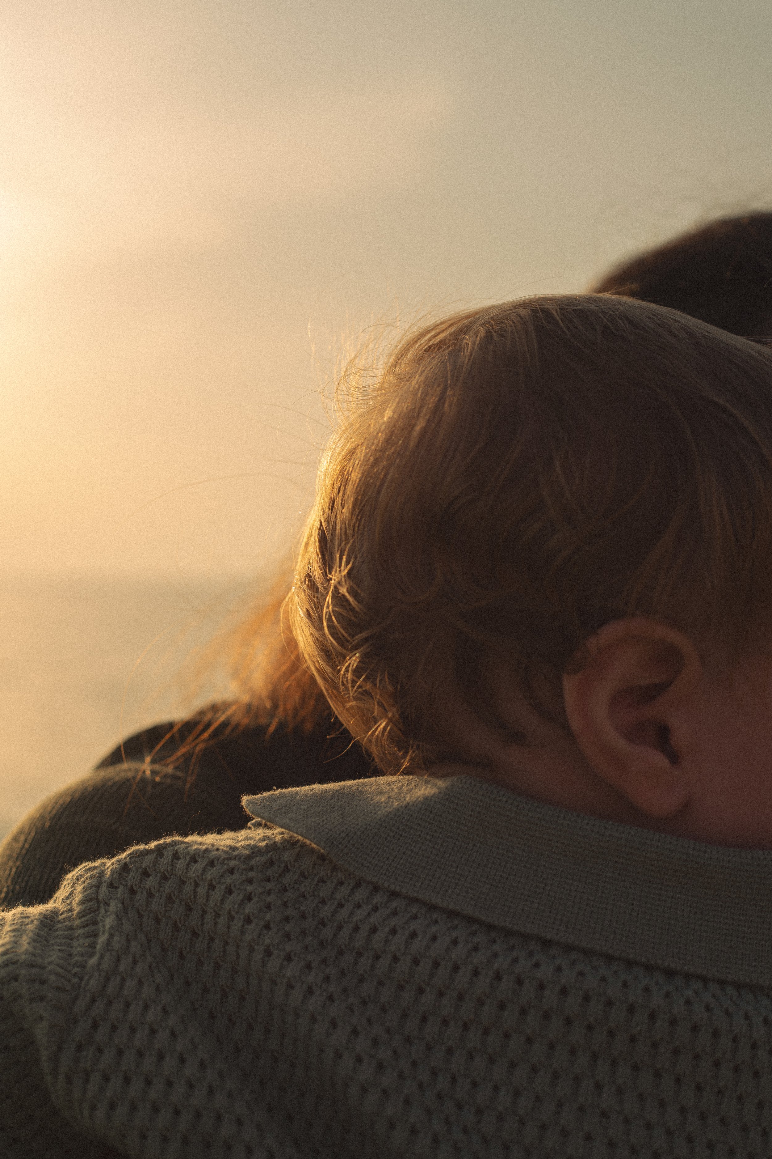 Close-up of a young child in warm evening light during a natural family photography session in Dubai.