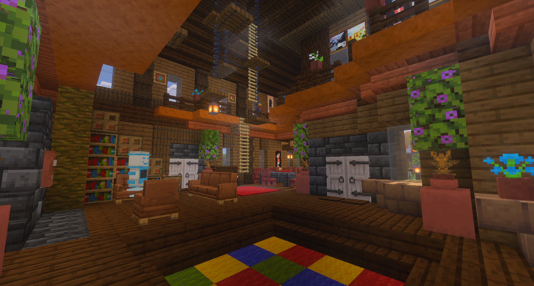 Interior of a Minecraft house with wooden walls, furniture, plants, bookshelves, and colorful carpet.