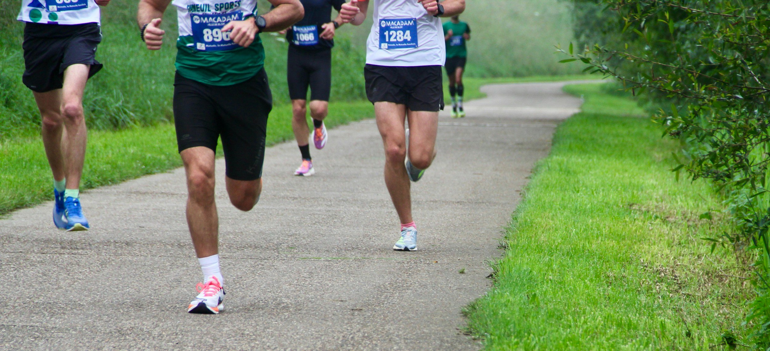 Group of runners competing in a road race, representing the 1:1 coaching clients of Ricey Runs Coaching