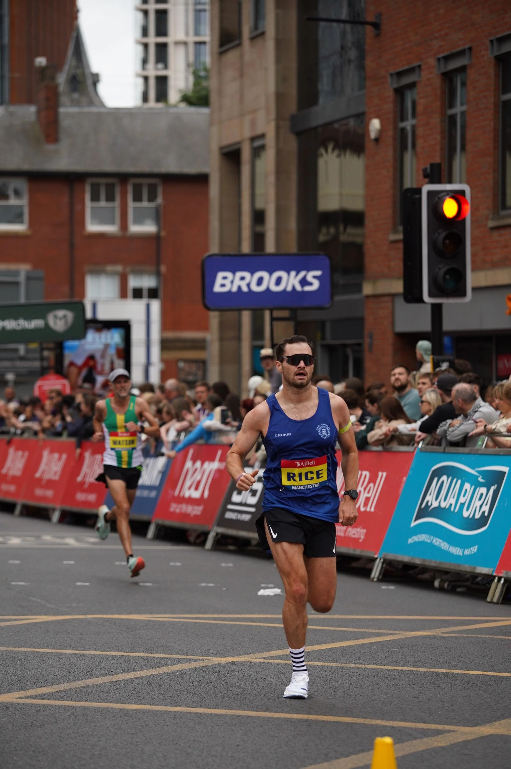 Runners competing in a Brooks sponsored road race in a city
