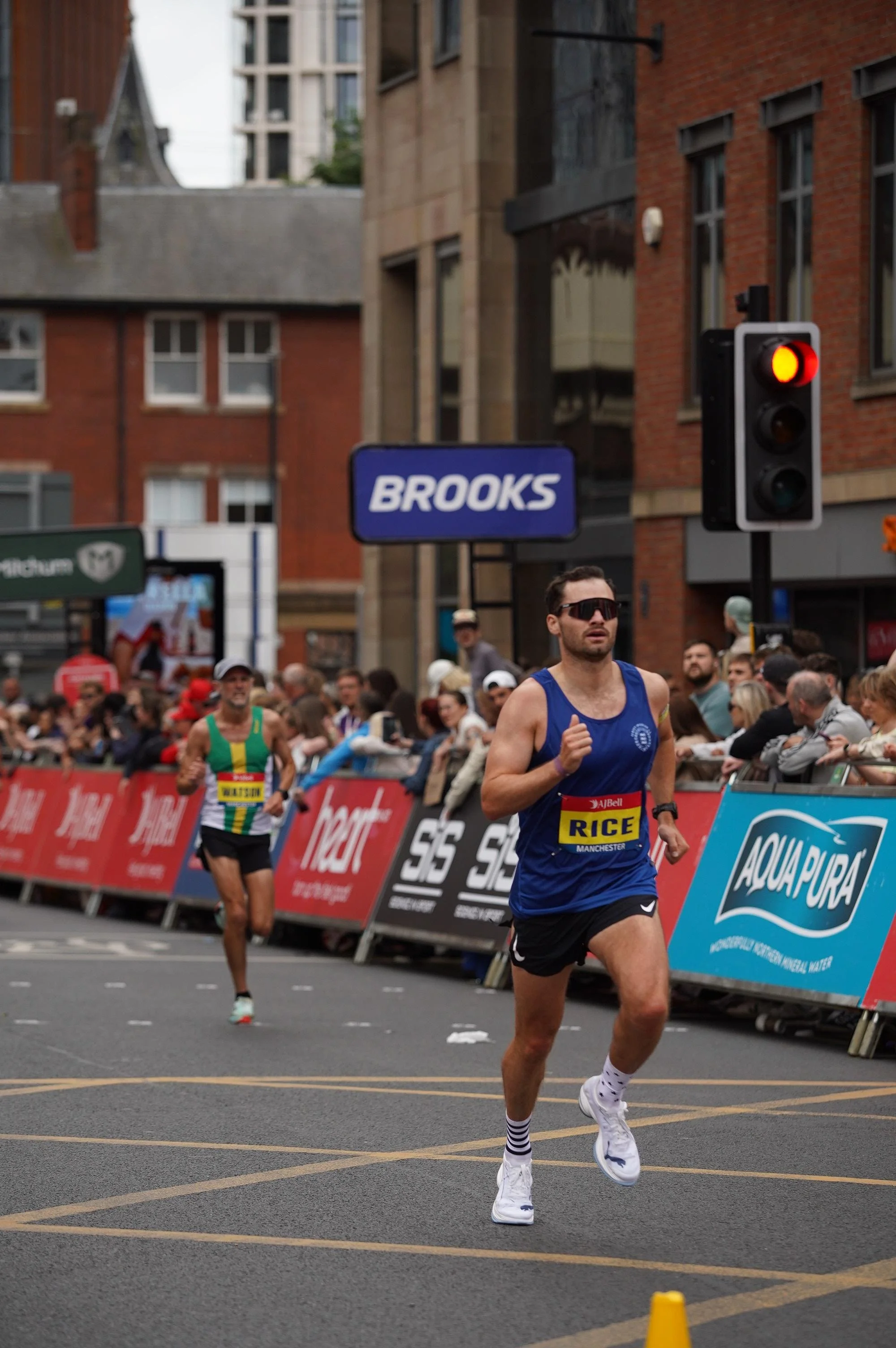 George Rice, running coach at Ricey Runs Coaching, competing in a road marathon wearing a RICE race singlet