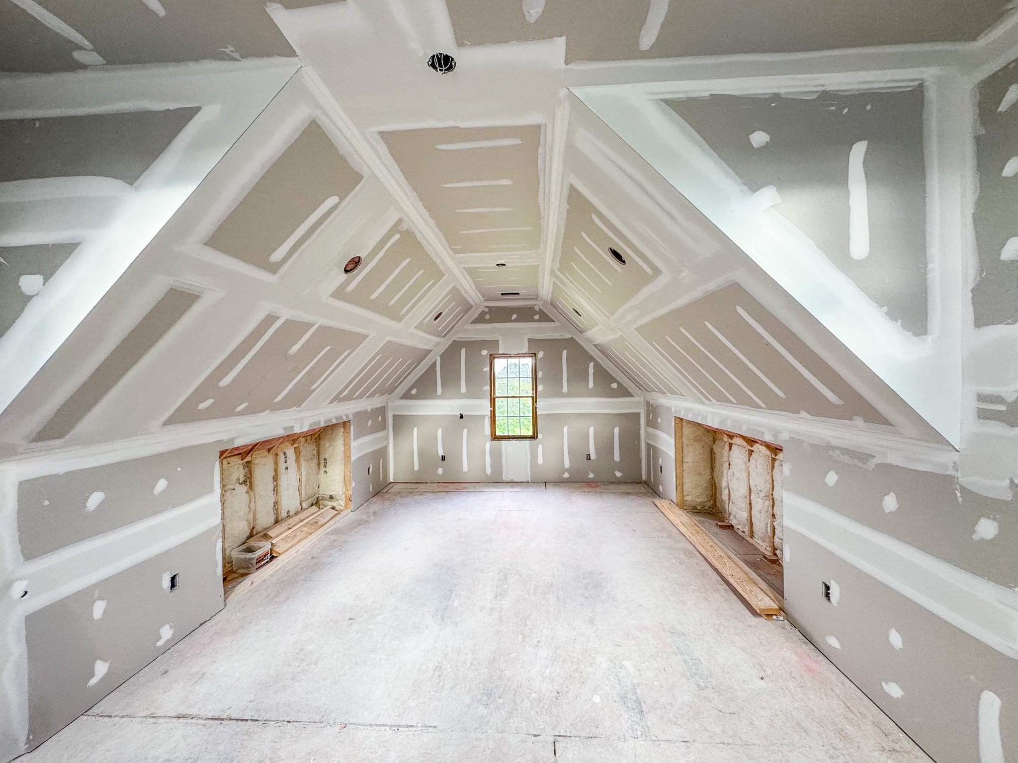 Attic build-out with insulation installation and framing in progress during renovation in Fuquay-Varina NC