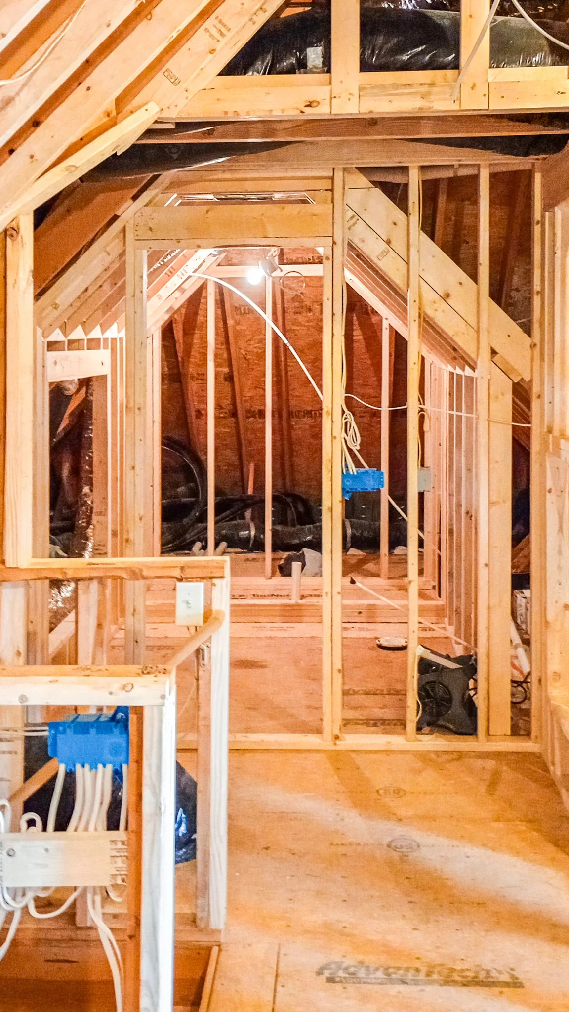 Finished attic build-out with vaulted ceilings, custom storage, and hardwood flooring in Fuquay-Varina NC
