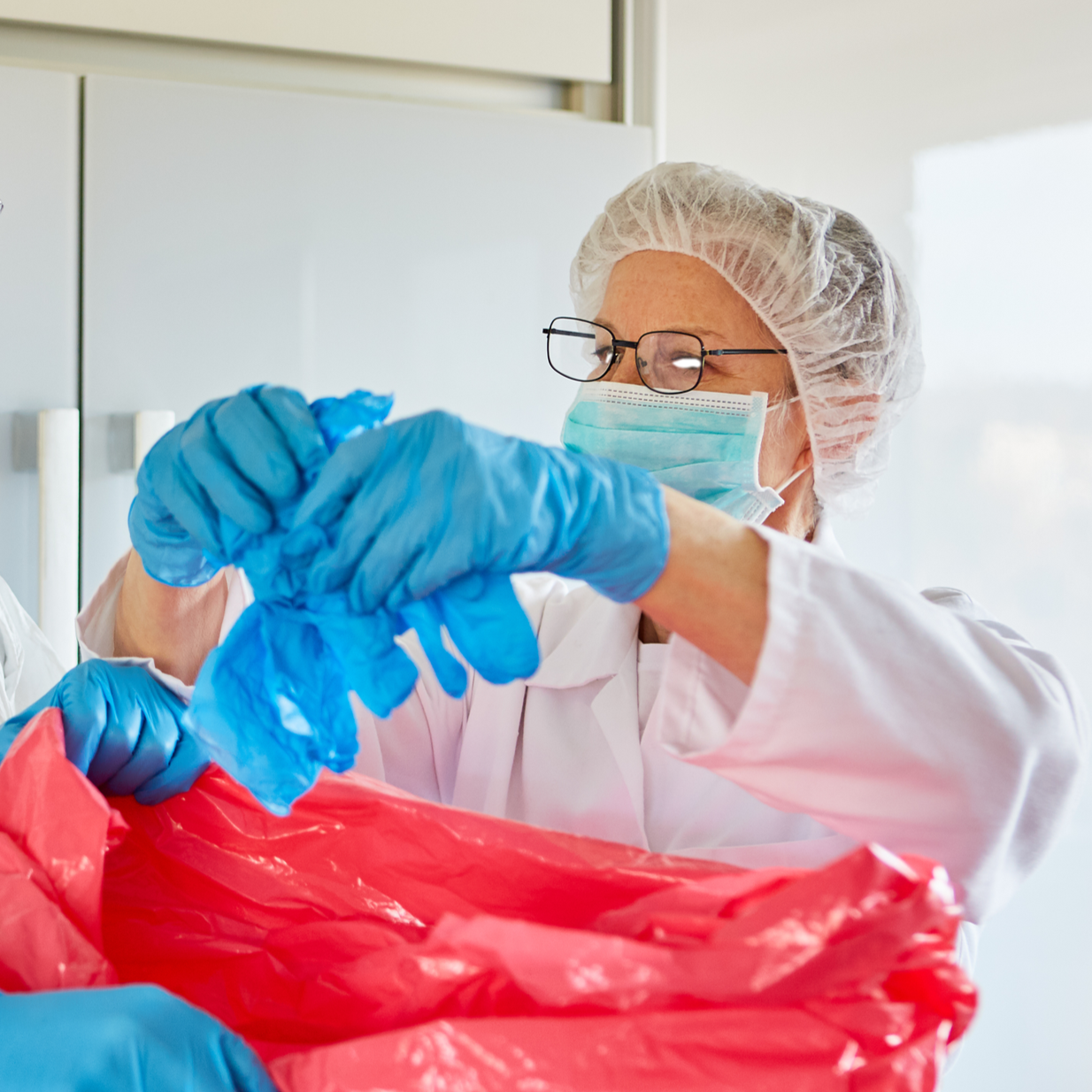 woman disposing of clinic waste