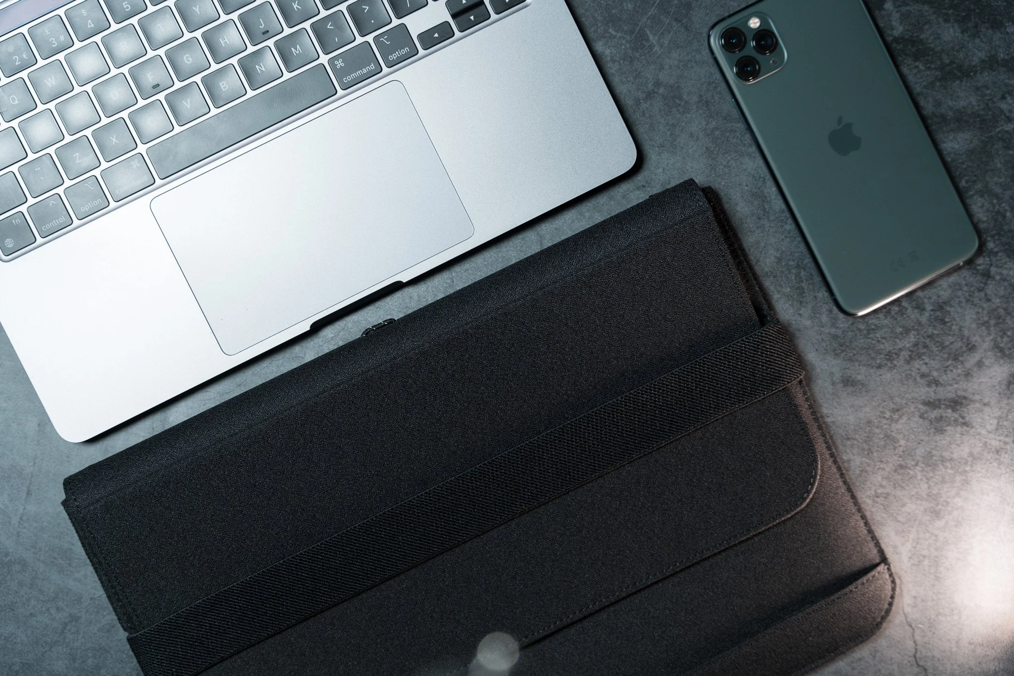 iMac, DeltaHub Laptop Bag, and iPhone