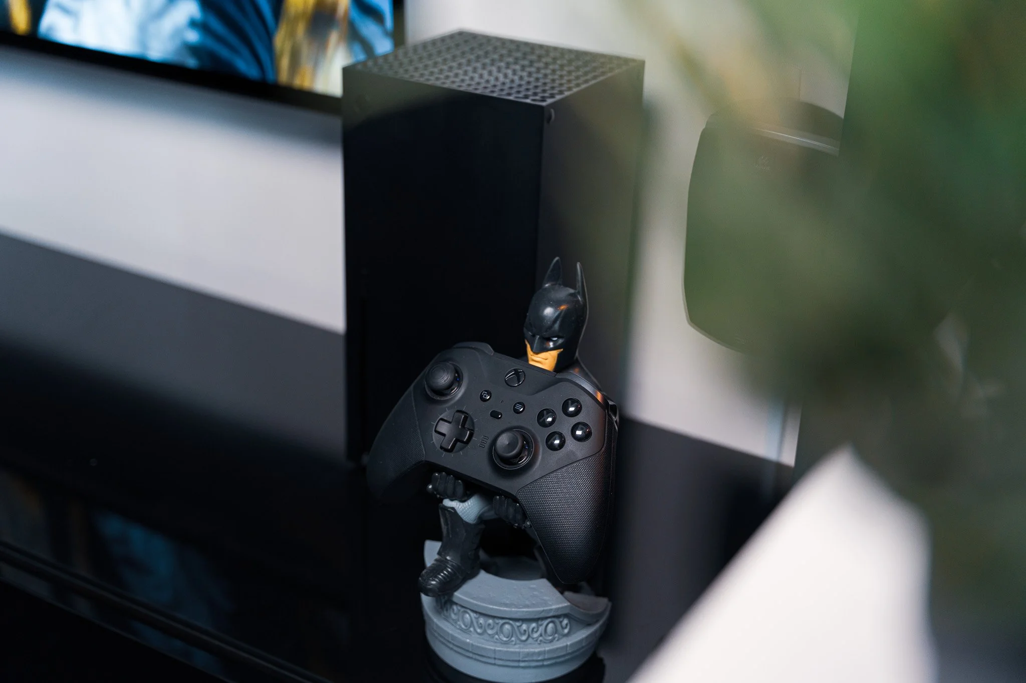Xbox Controller and Cable Guys Stand propped against the Xbox Series X