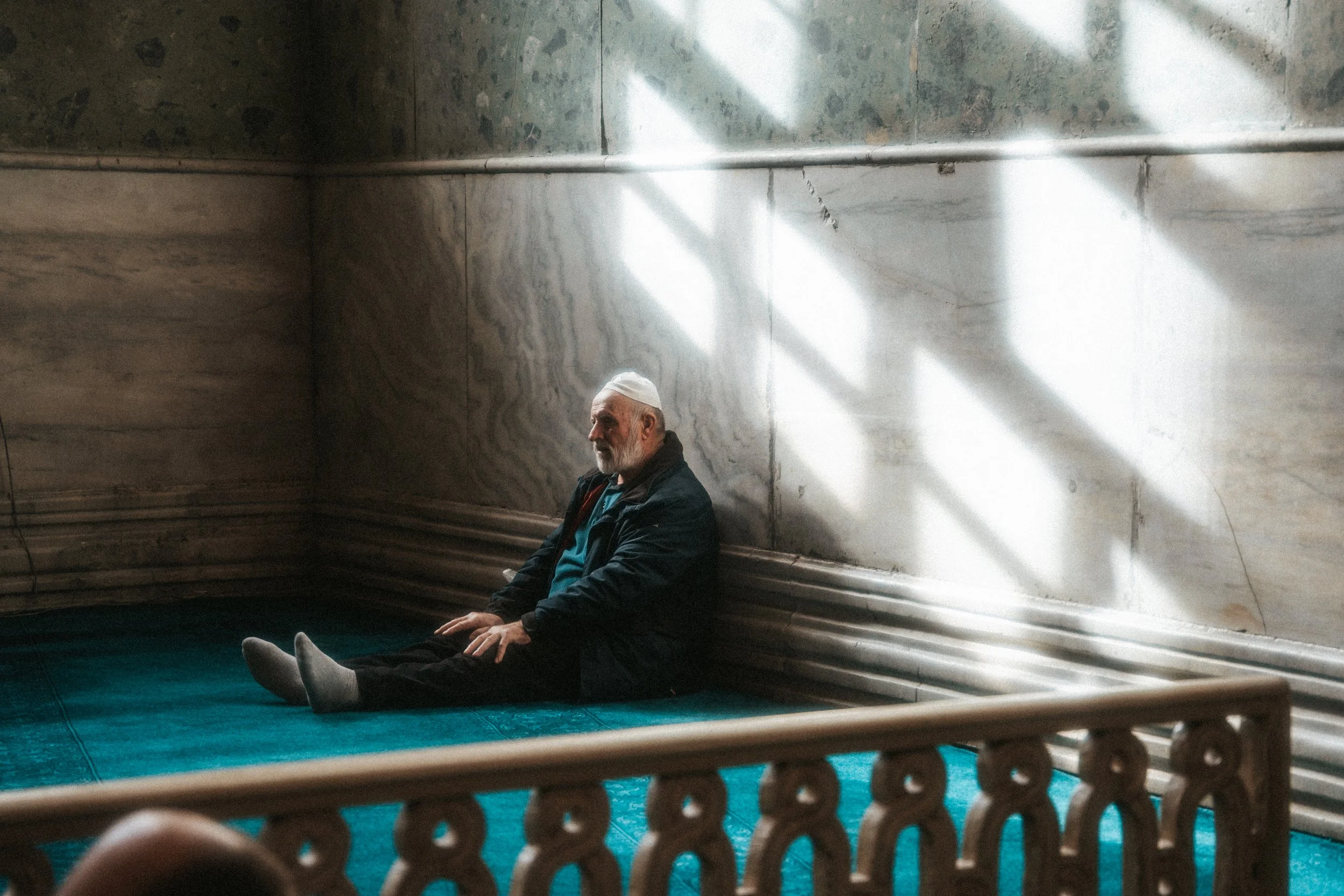 Old man praying at the mosque