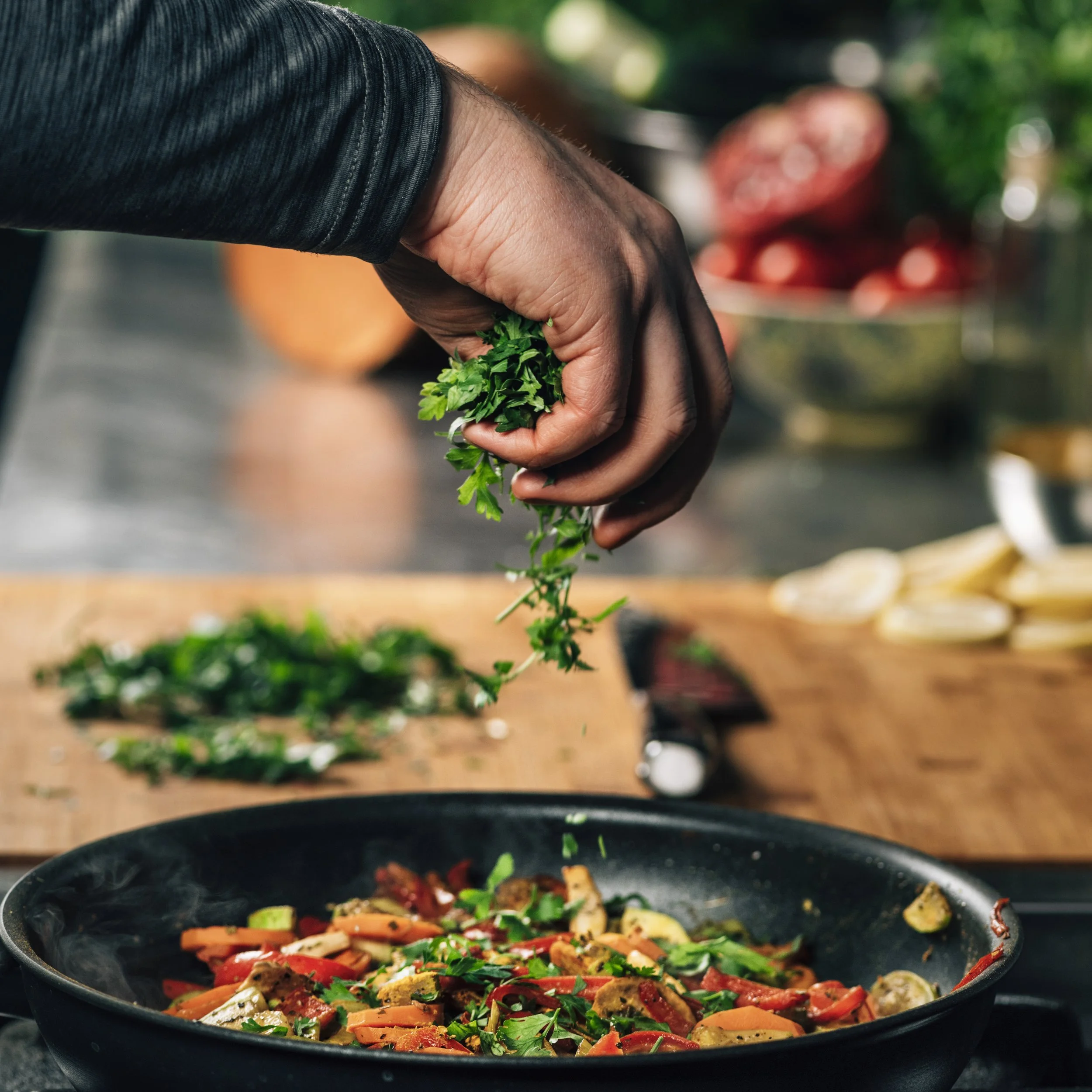 hand-adding-parsley-into-frying-pan-with-vegetable-2023-11-27-04-54-49-utc.jpg