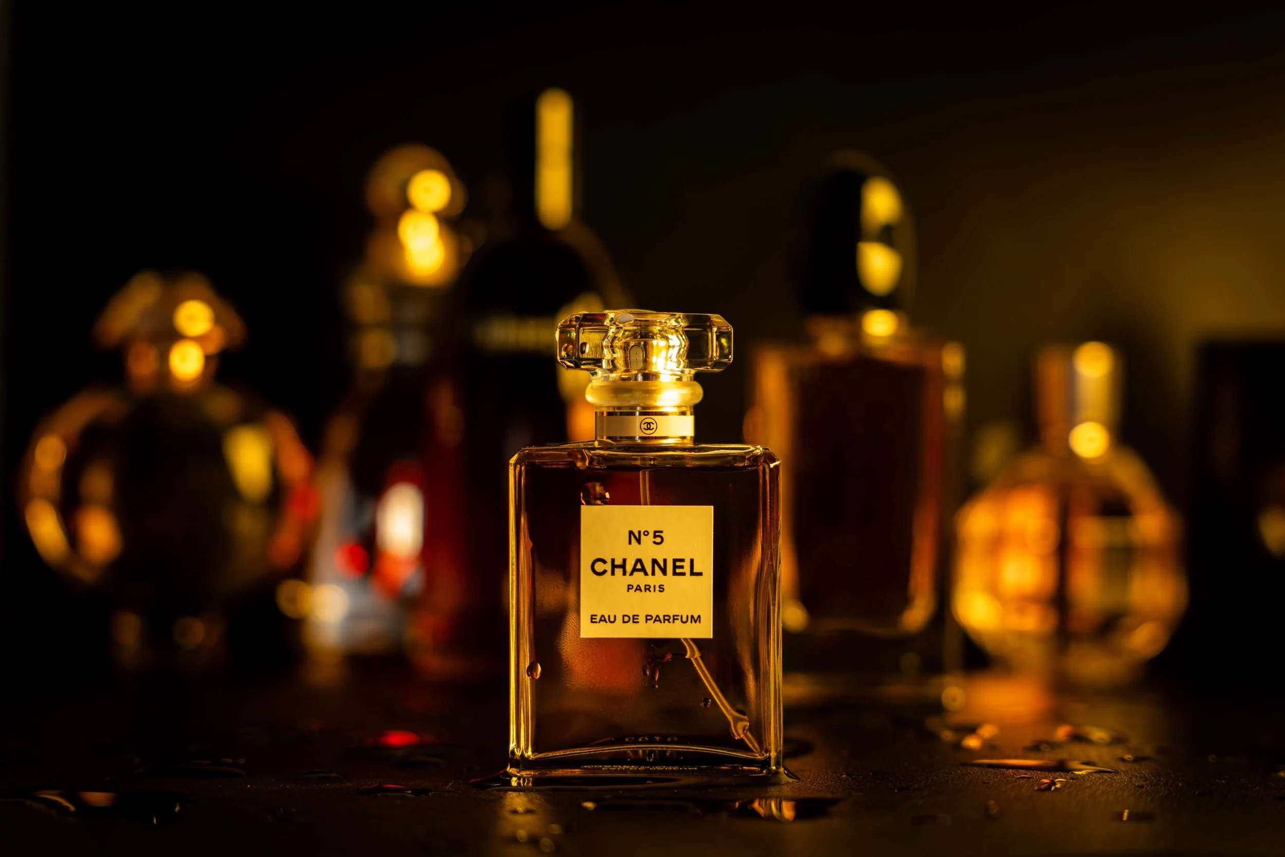 No 5 Channel Perfume in front of collection of luxury perfumes