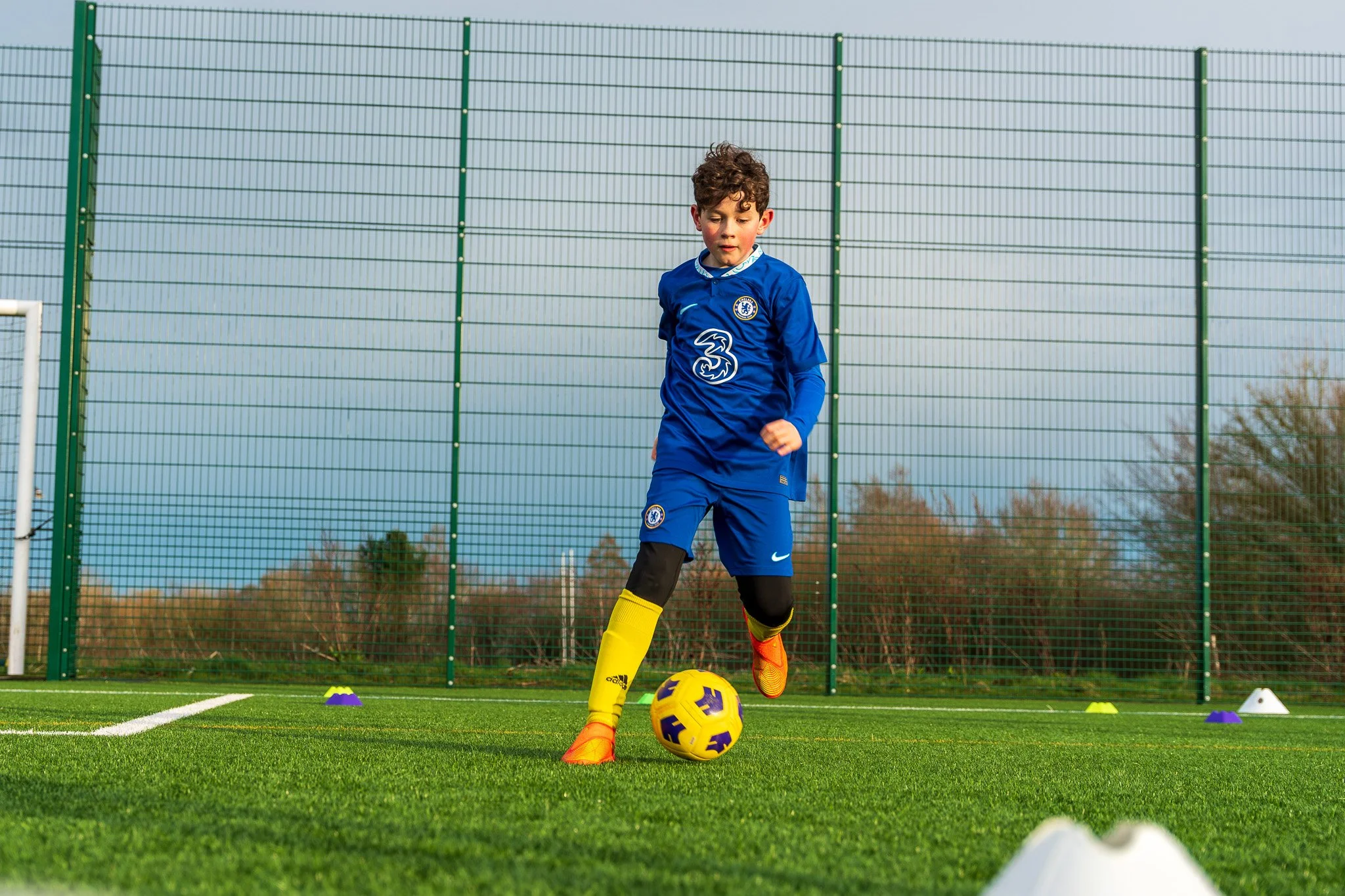 Child playing football at The Titans Football Academy in Chesham