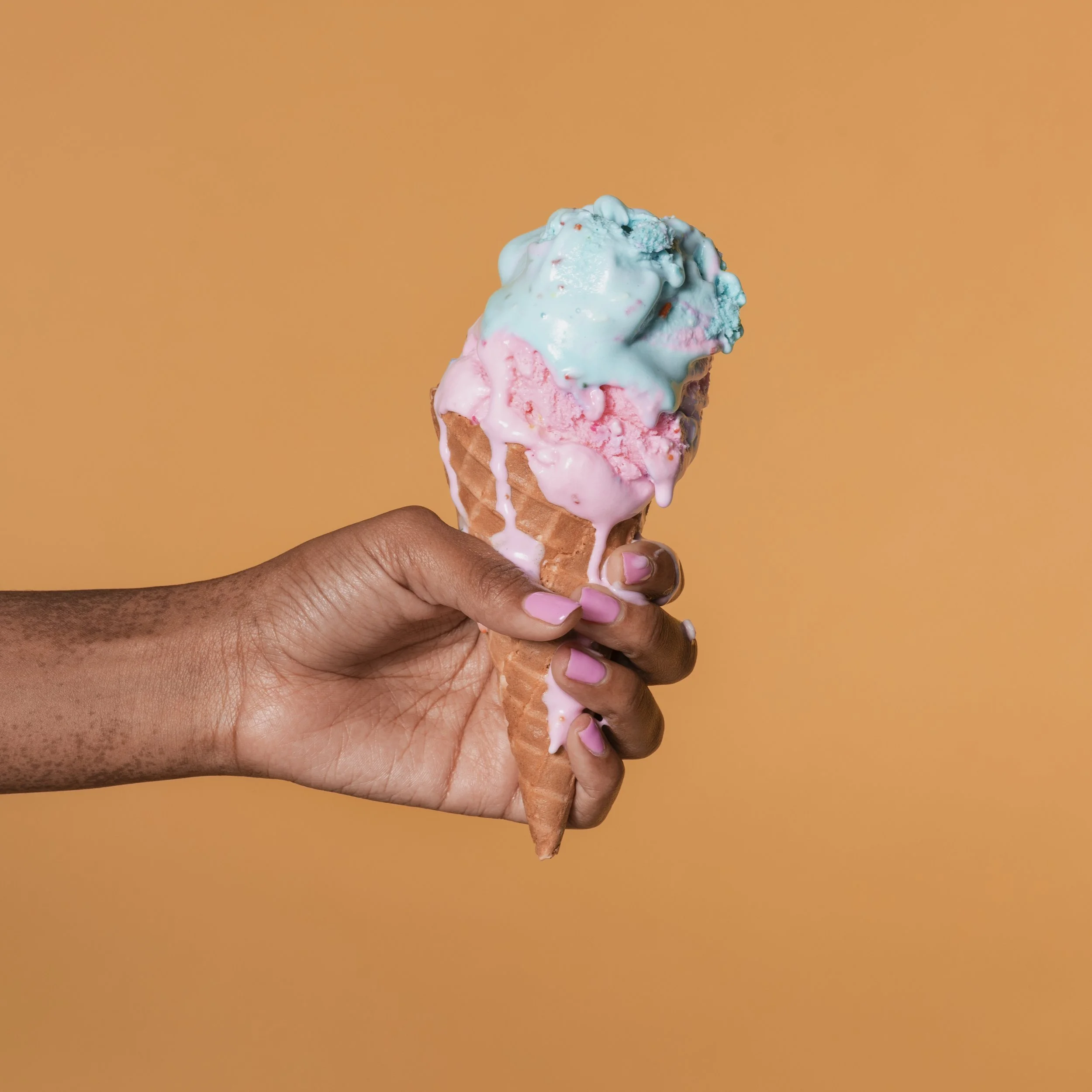 hand-holding-a-delicious-pink-and-blue-ice-cream-2026-03-18-12-03-26-utc.jpg