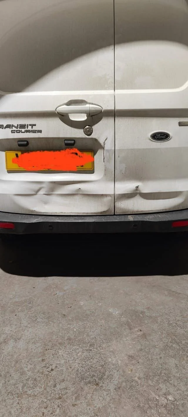 Before - Deep dent and crease damage to the rear panel

