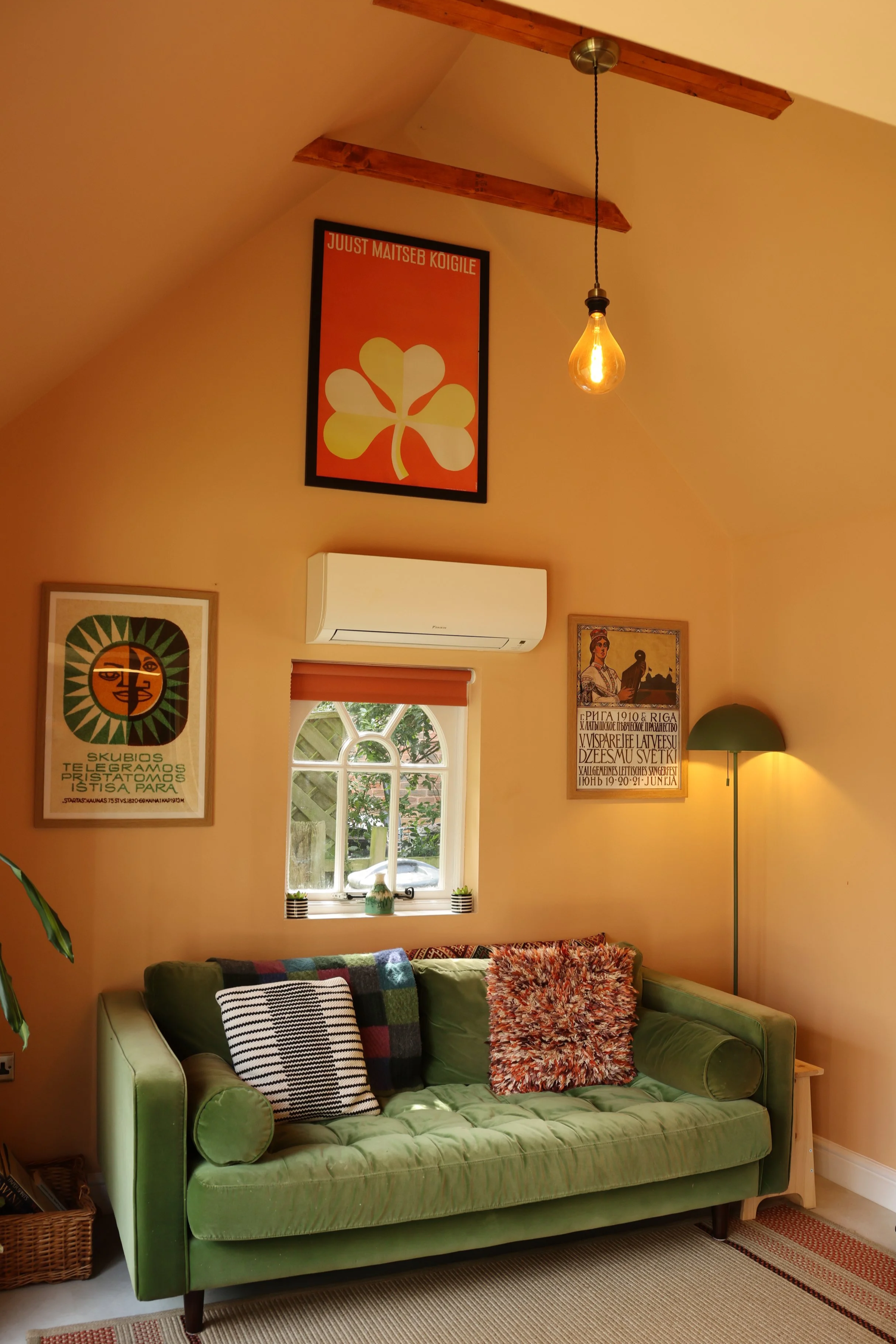 Therapy room with vaulted ceiling and green sofa at Cedarwood Therapy, Adel